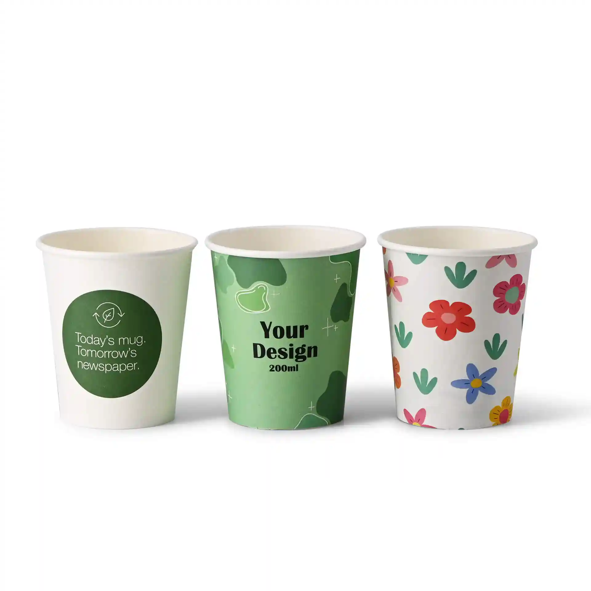 Three paper cups with different designs: one with a green logo, one with a green pattern and text, and one with colorful flowers.