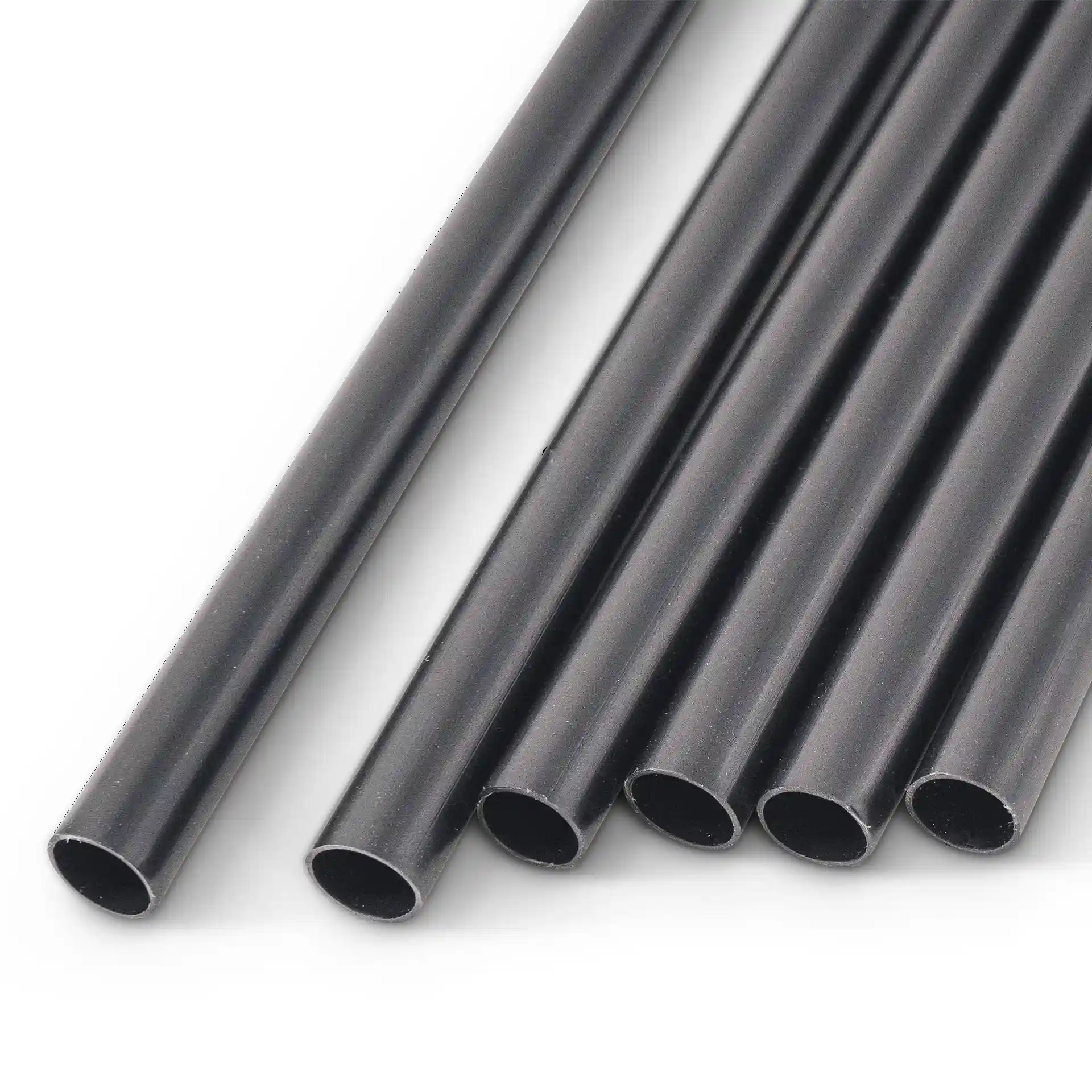 Black reusable straws, 22 cm long and 0.7 cm in diameter, arranged in a group on a plain background.