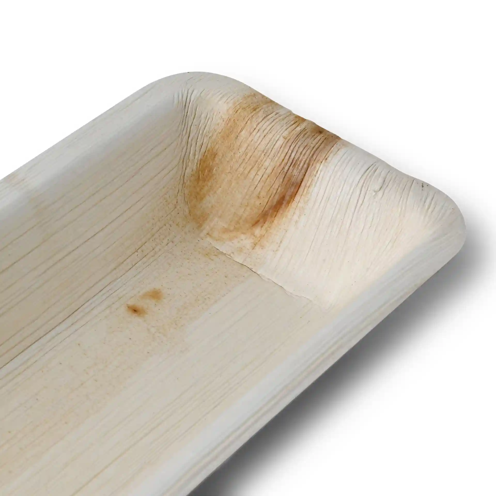 Rectangular palm leaf tray with a textured grain surface and slight discoloration in one corner.
