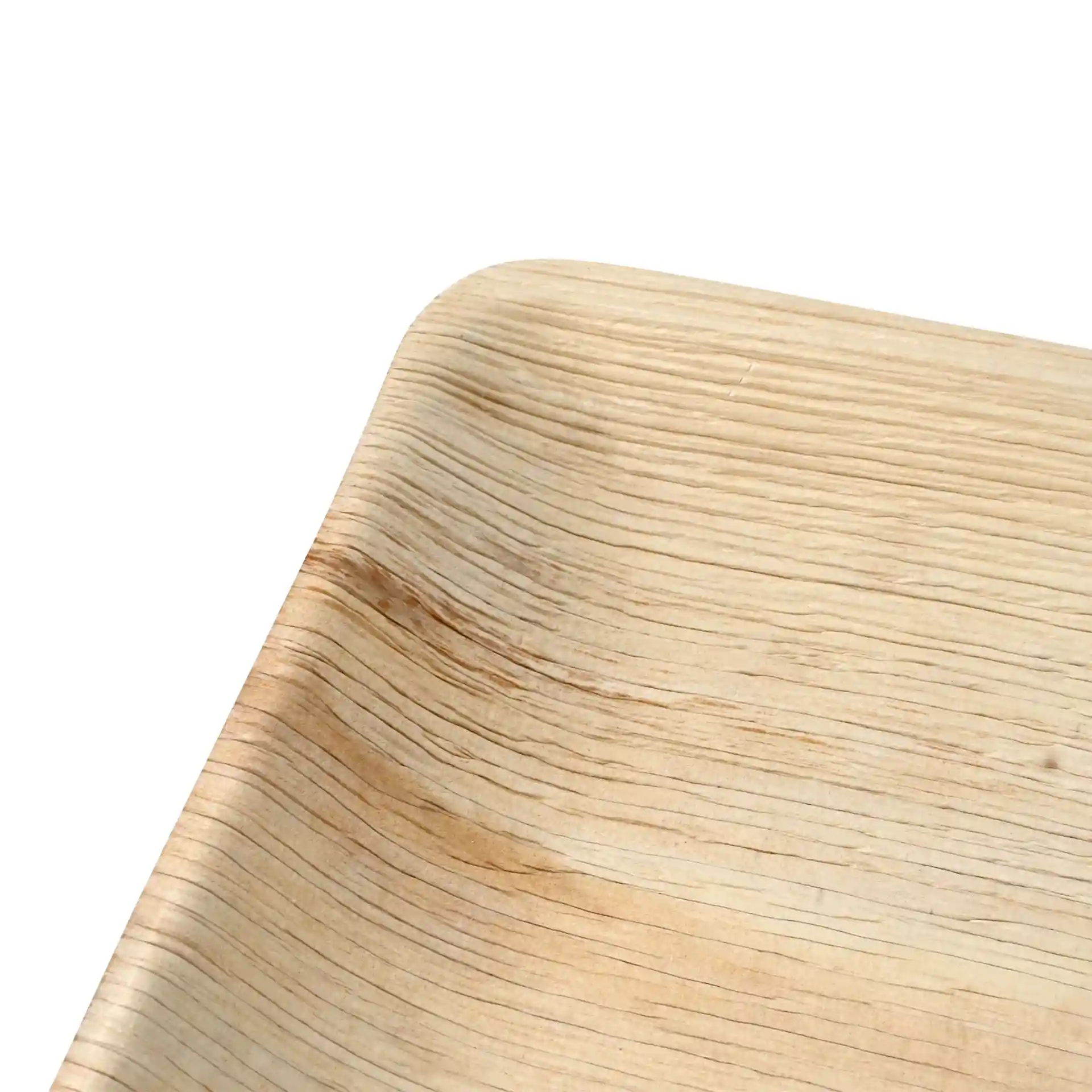Close-up of a square palm leaf plate with a natural grain pattern and rounded edges.
