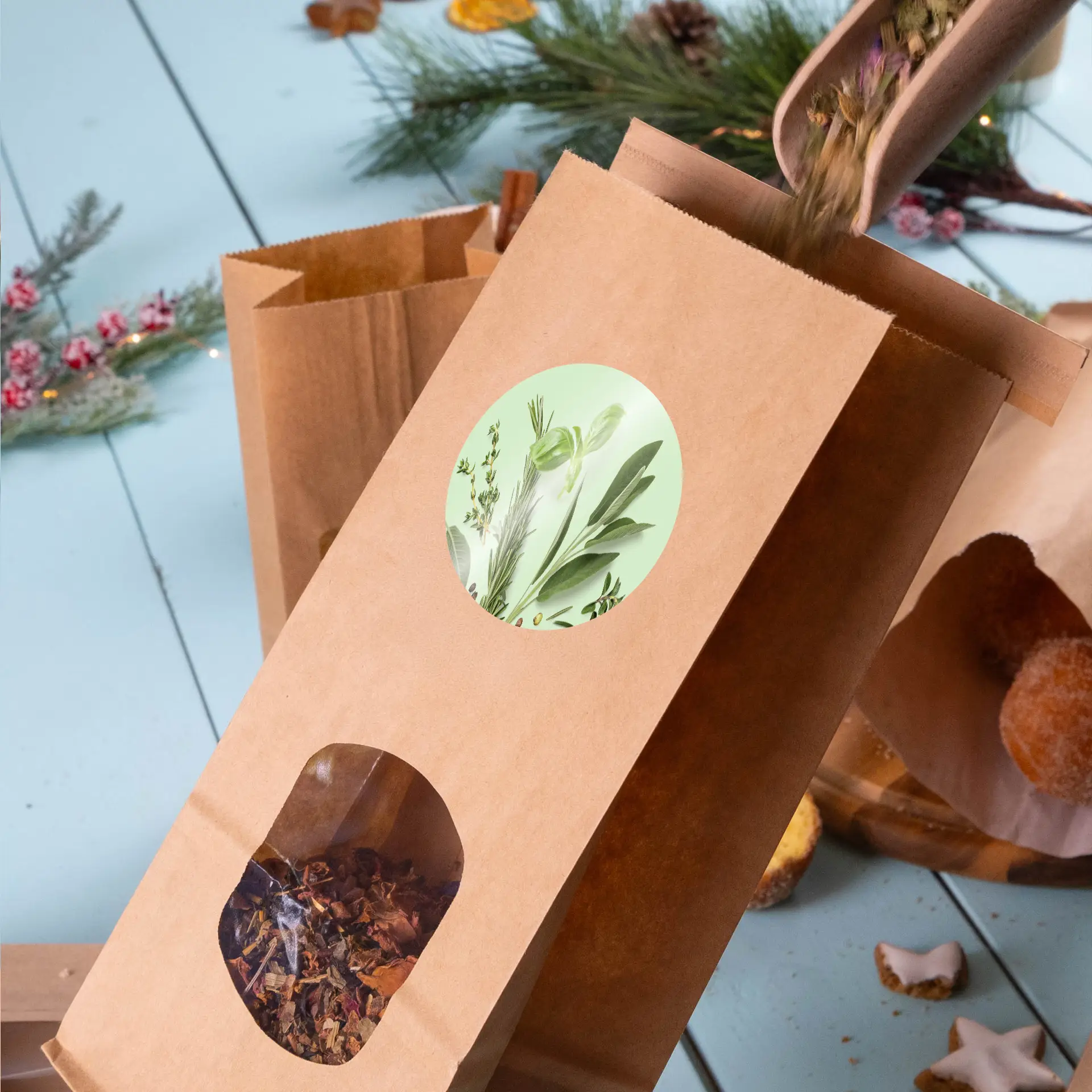 Brown kraft paper bag with a window showing dried herbs, featuring a round label with botanical design.