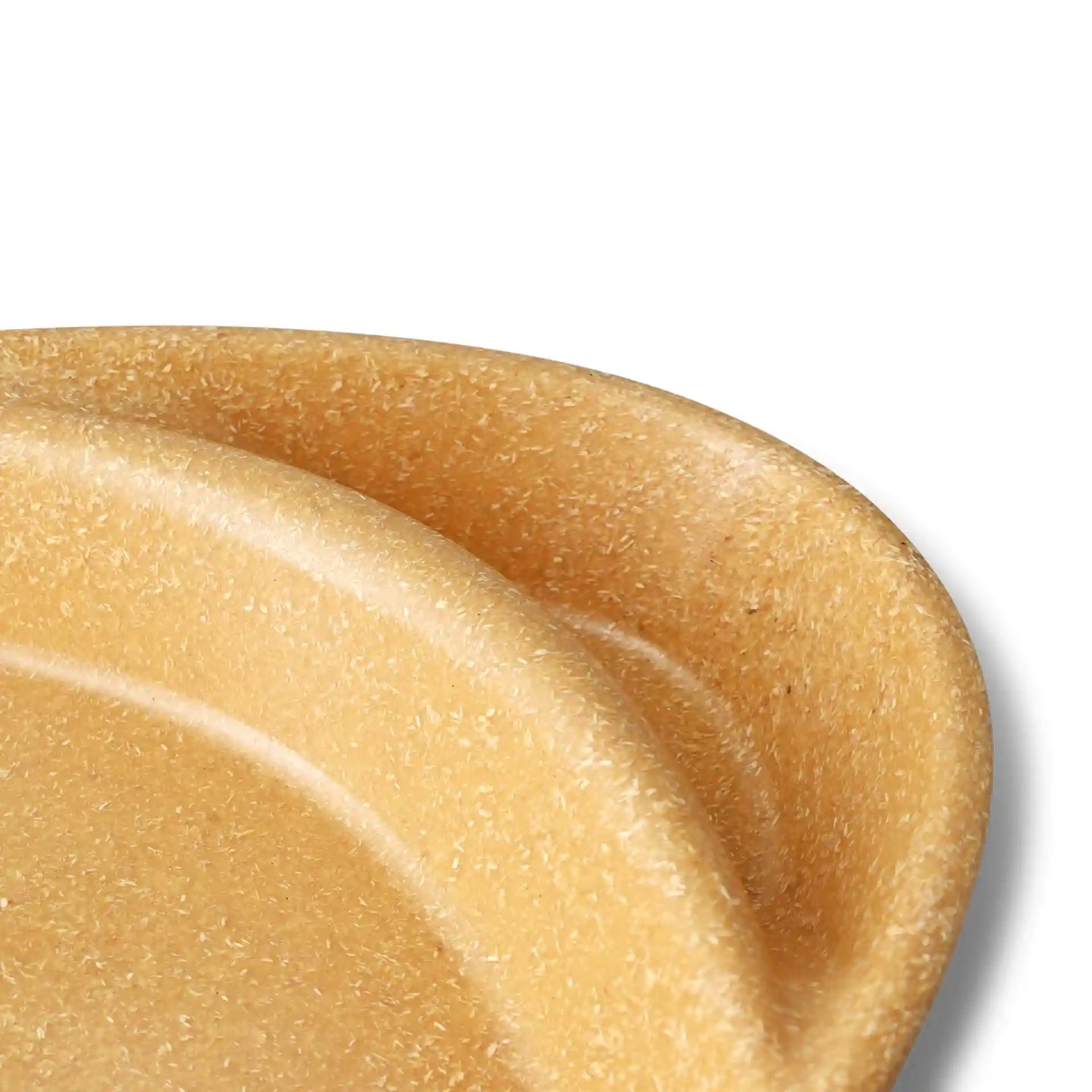 Close-up of two caramel-colored reusable divided plates with a smooth surface and rounded edges.