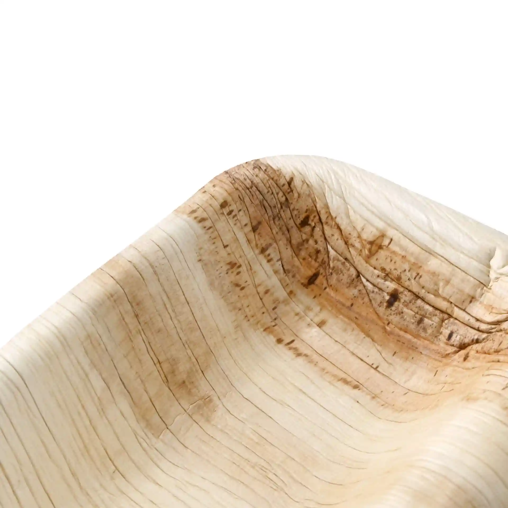 Close-up of a rectangular palm leaf dinner plate with two compartments, showing natural grain and texture.
