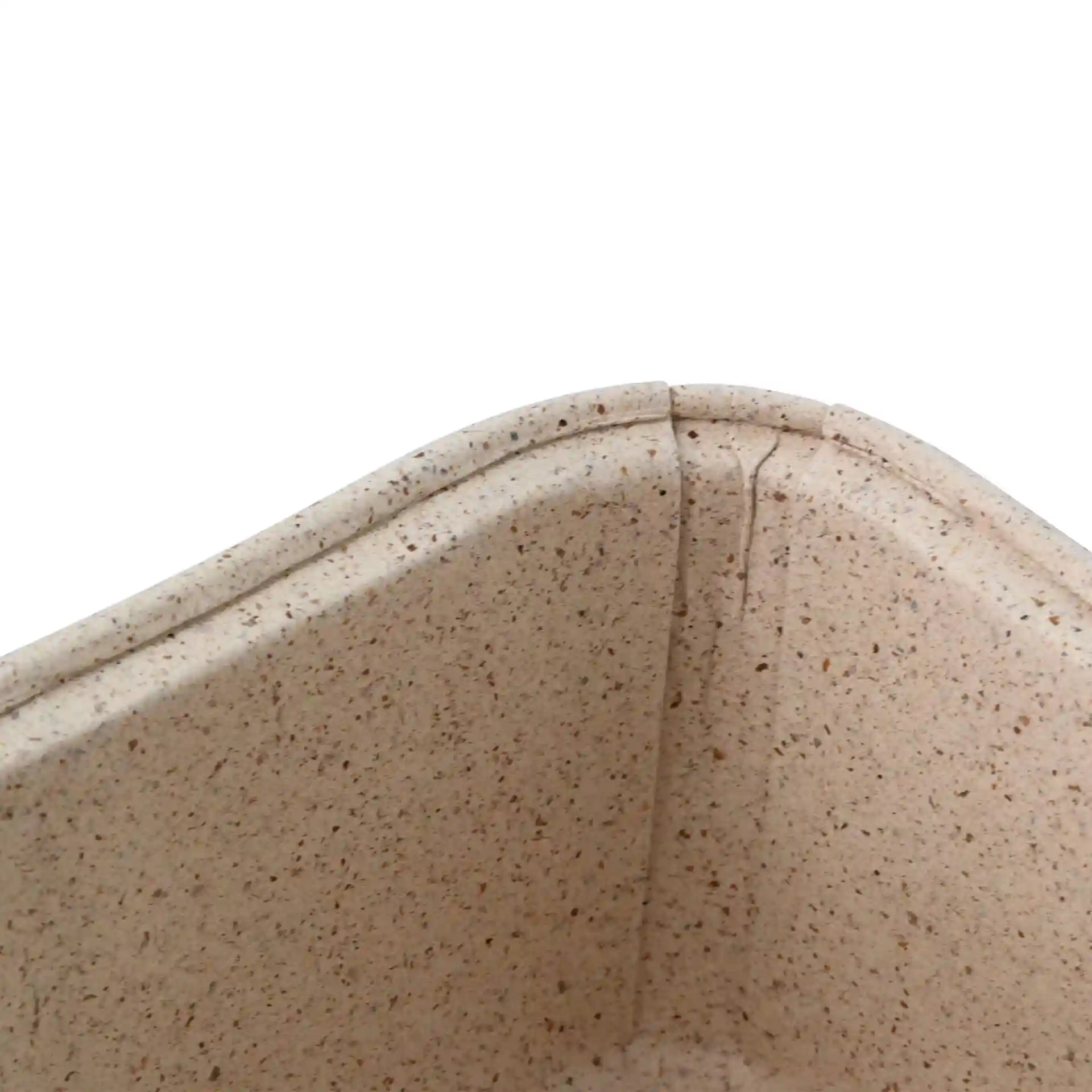 Close-up of a brown rectangular baking mould made from cocoa paper, showing the corner and texture details.