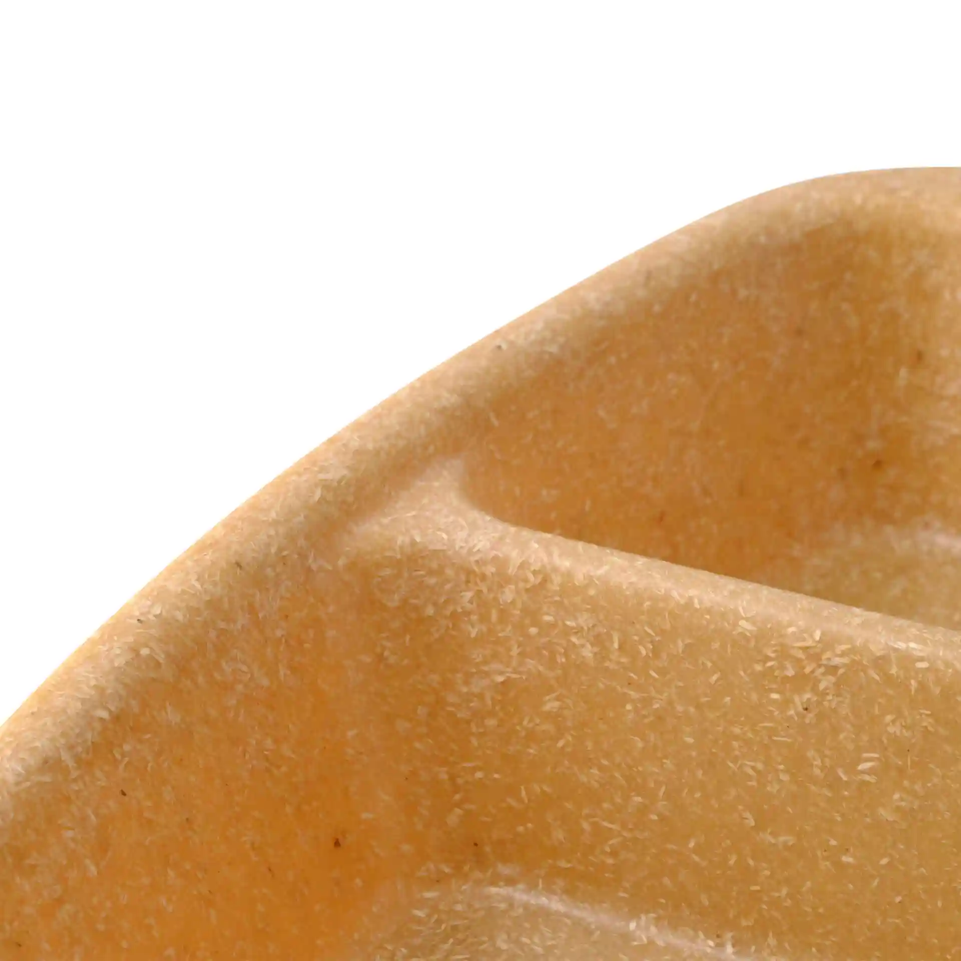 Close-up of a caramel brown reusable meal container with two compartments and a textured surface.