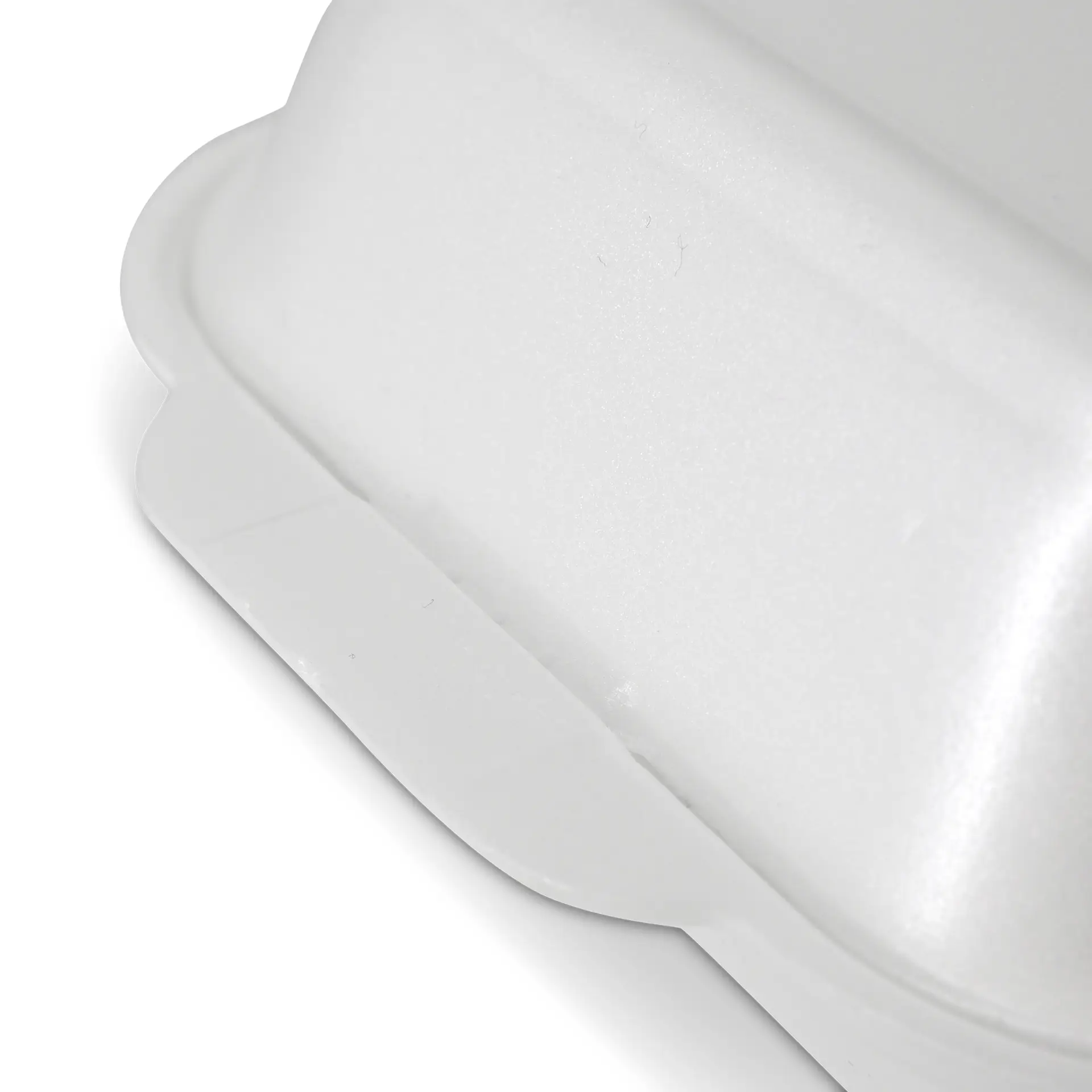 White foam takeout container with a hinged lid and a smooth surface.