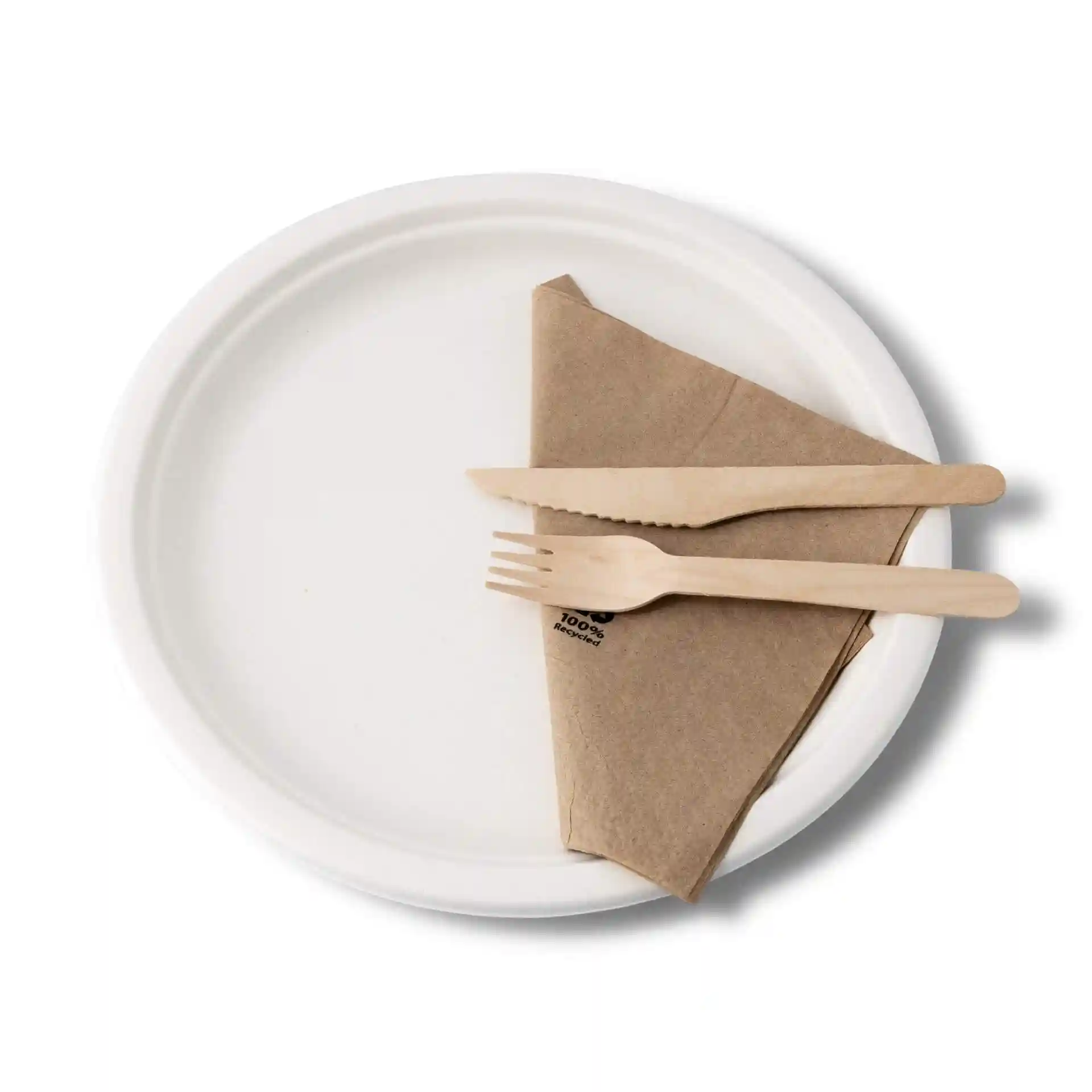 White round sugarcane plate with a brown napkin and wooden fork and knife on top.