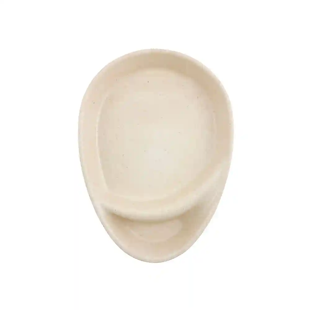 Ceramic dish in an oval shape with a smooth, beige surface and a small lip on one side.