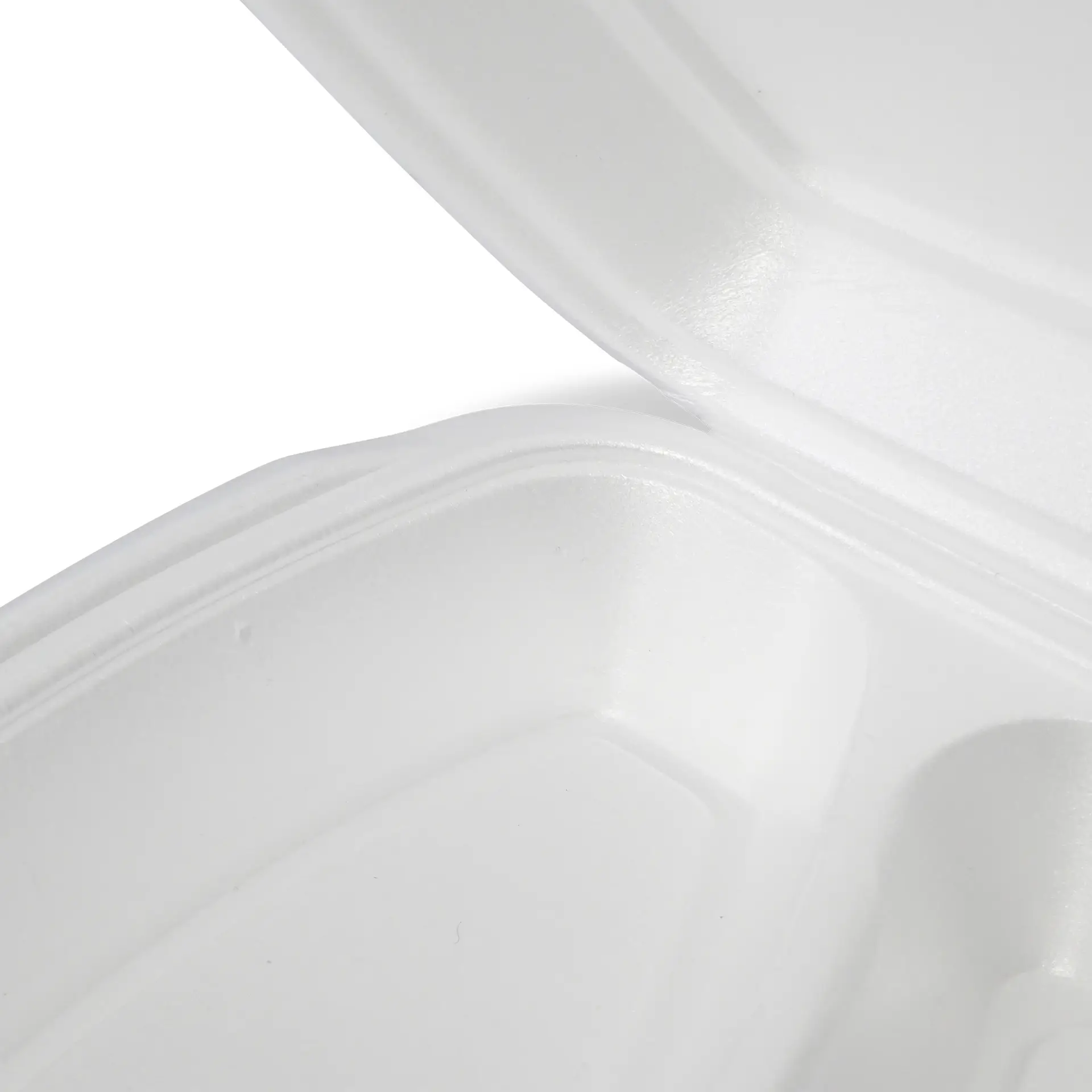 White disposable food container with a hinged lid, showing the interior space.