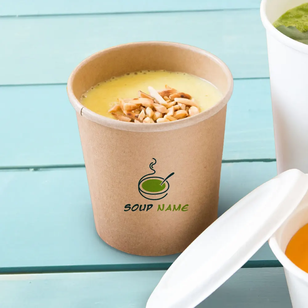 Brown paper soup cup filled with soup and topped with nuts, labeled "Soup Name," on a blue wooden surface.