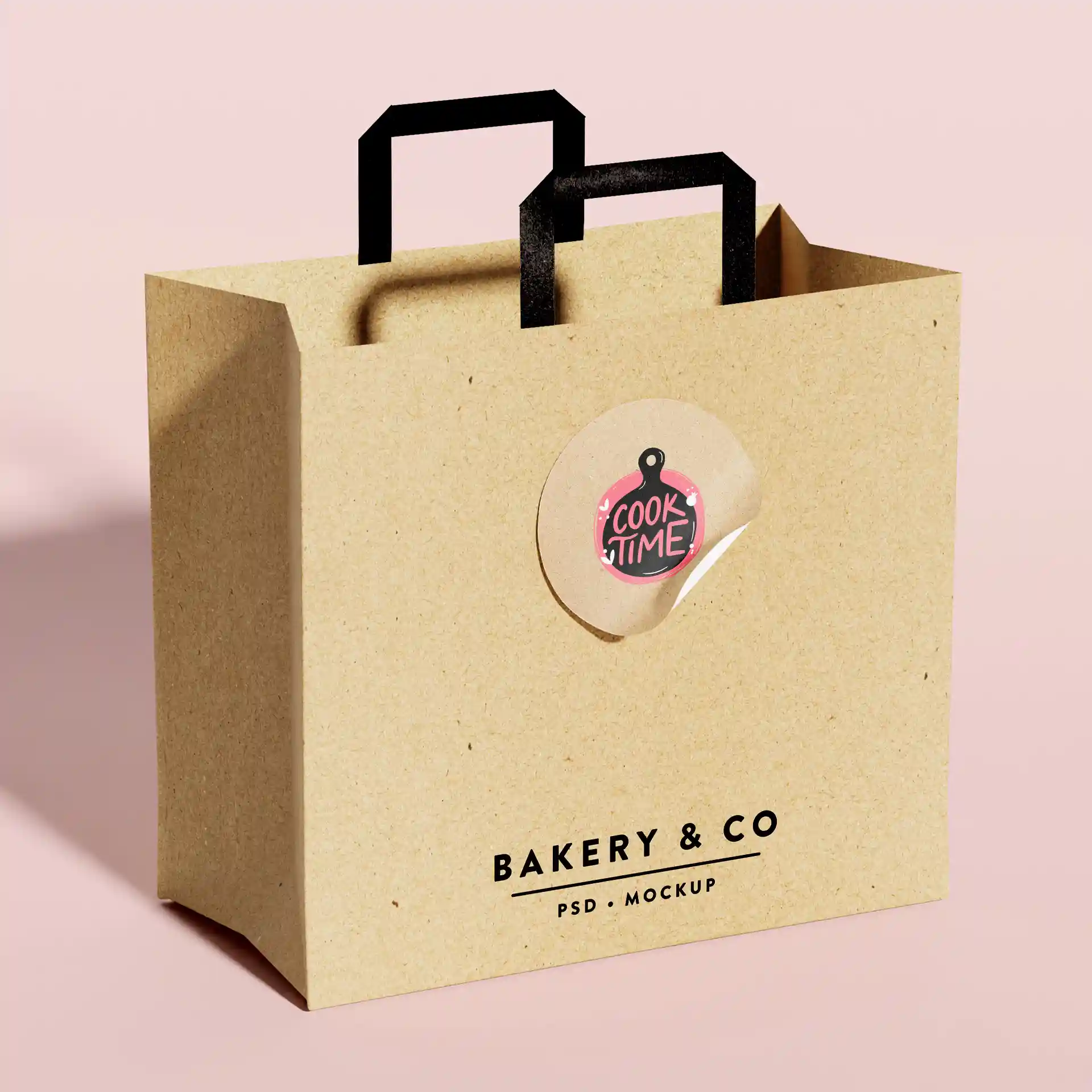 Brown kraft paper bag with black handles and a round label featuring a pink and black design.