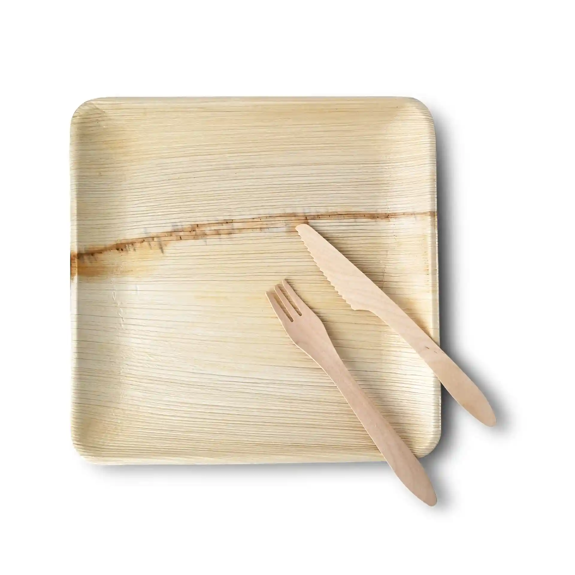Square palm leaf plate with a grain texture, accompanied by a wooden fork and knife.