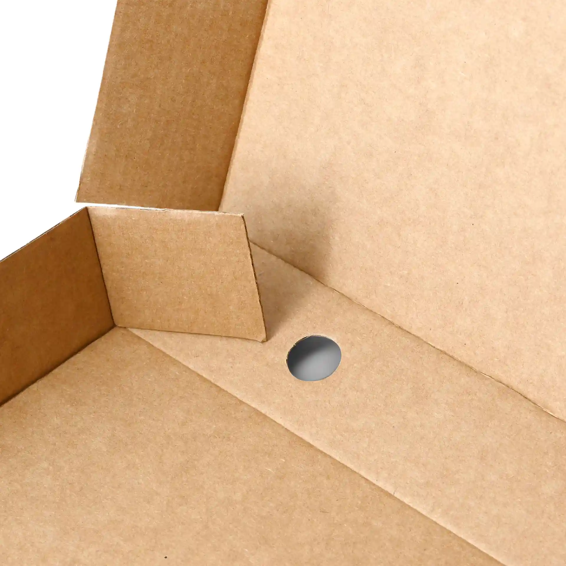 Close-up of a brown cardboard pizza box with a circular hole and folded flaps.