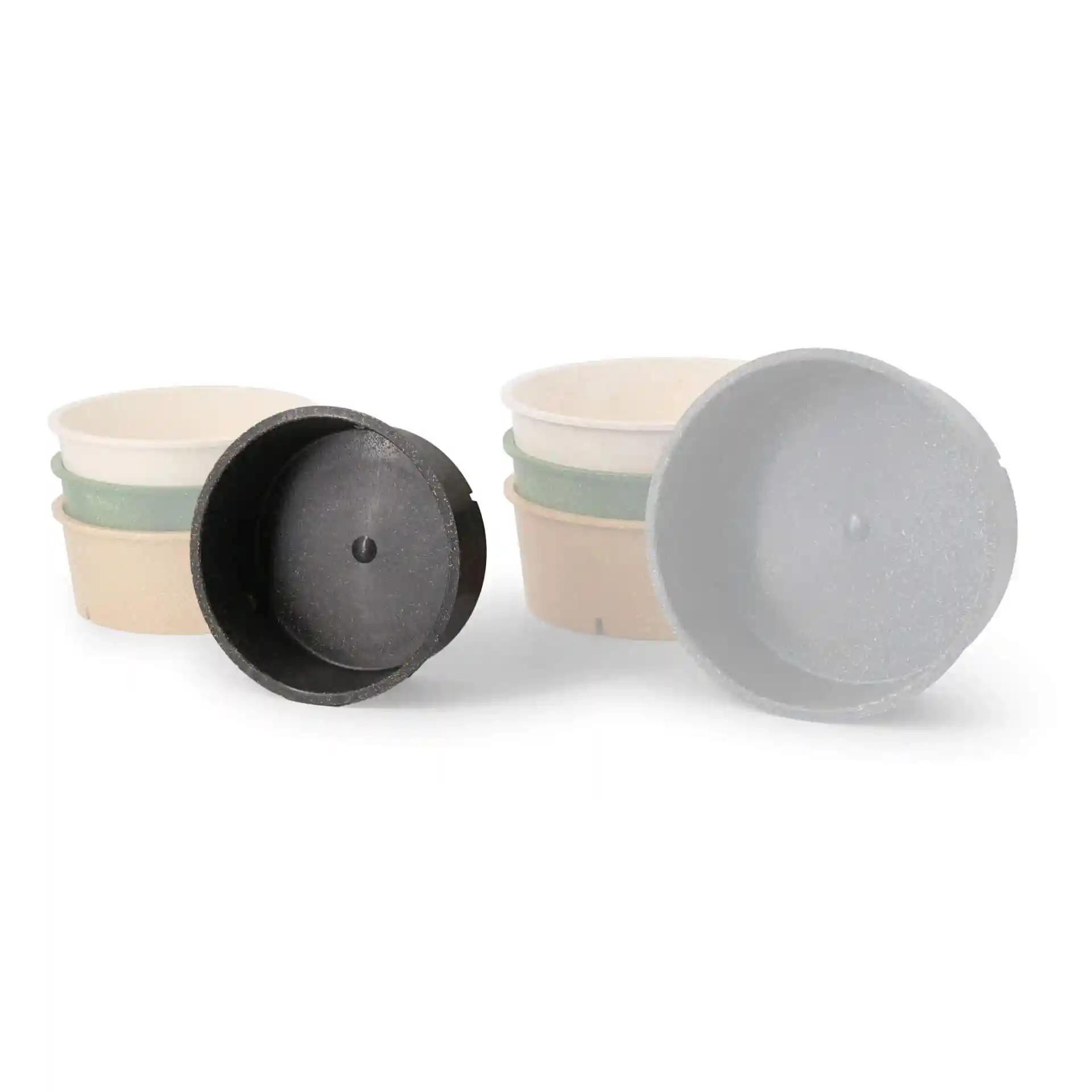 Image of several round reusable bowls in grey and pepper colors, with one bowl shown upside down.