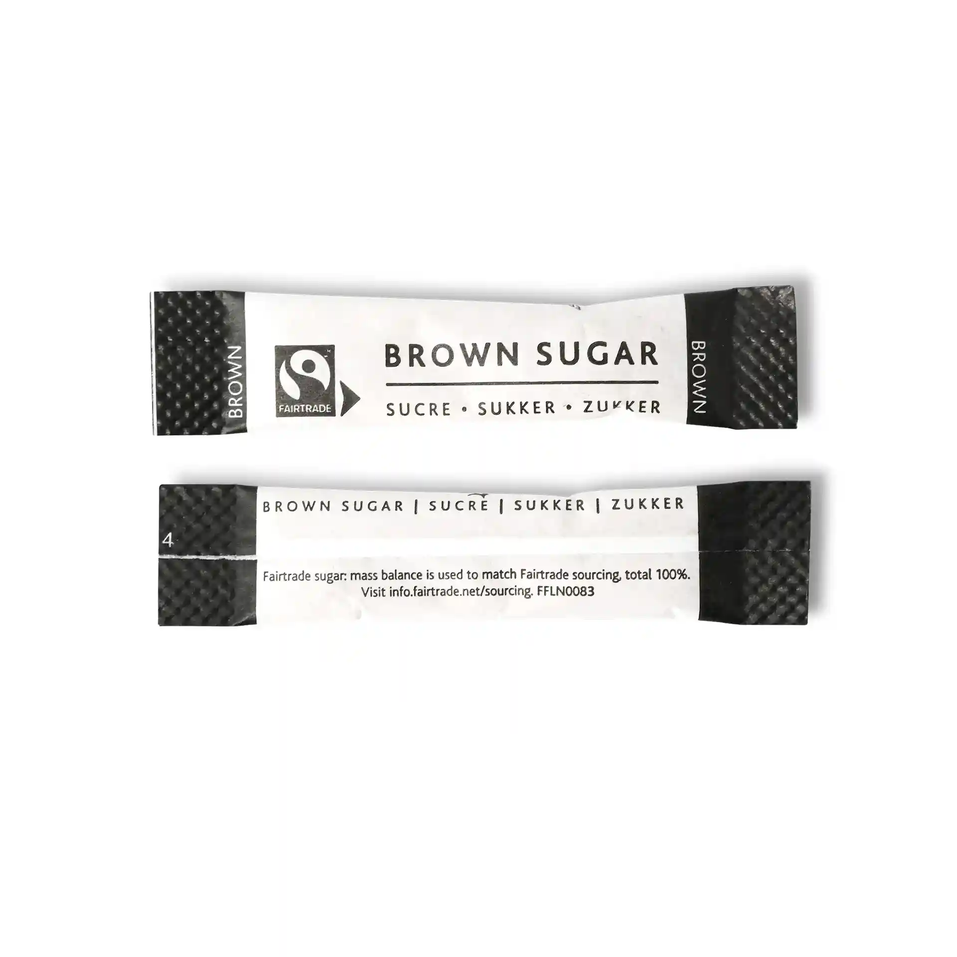 Brauner Zuckerstick mit Fairtrade-Logo, 74 mm x 16 mm, mit mehrsprachigem Text.