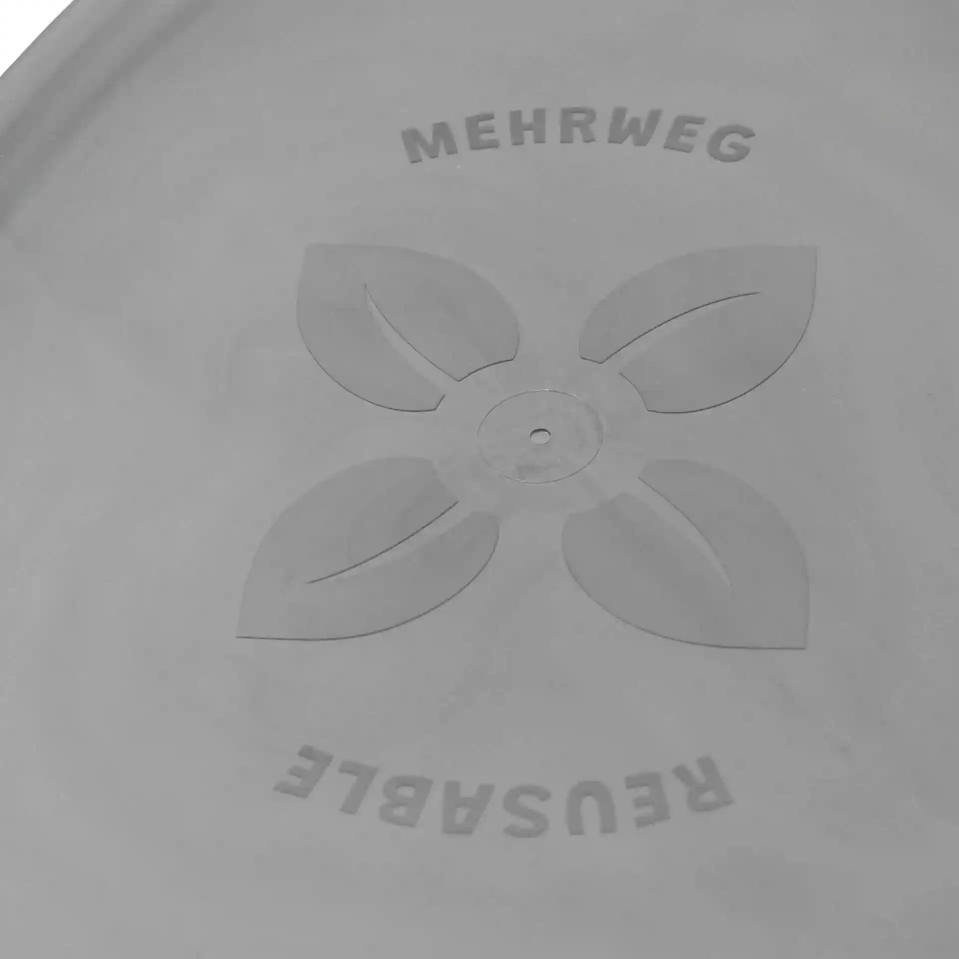 Oval grey reusable lid with a central hole and leaf design, featuring the words "MEHRWEG" and "REUSABLE".