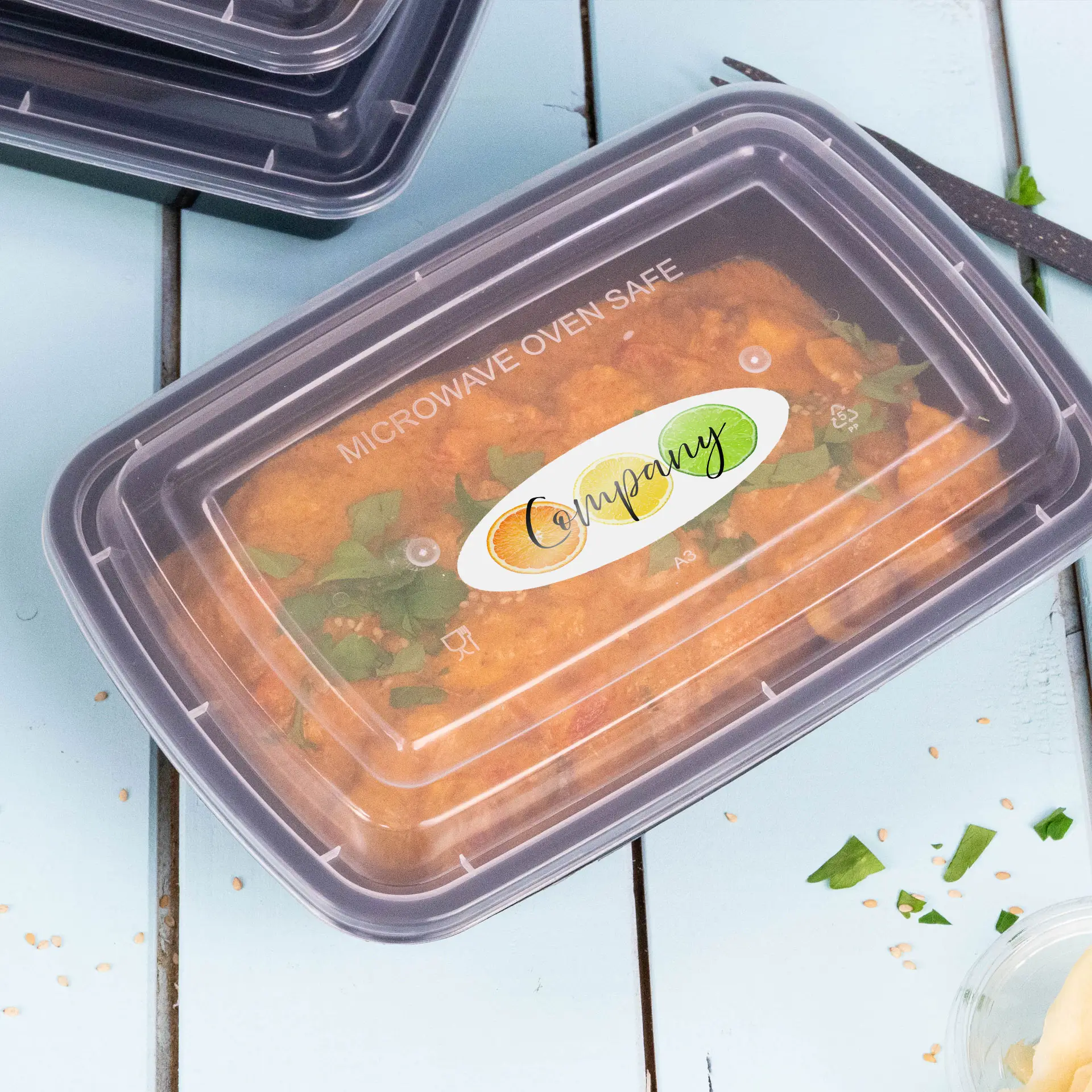 Clear plastic food container with a microwave-safe lid, featuring a label displaying the company name and logo.