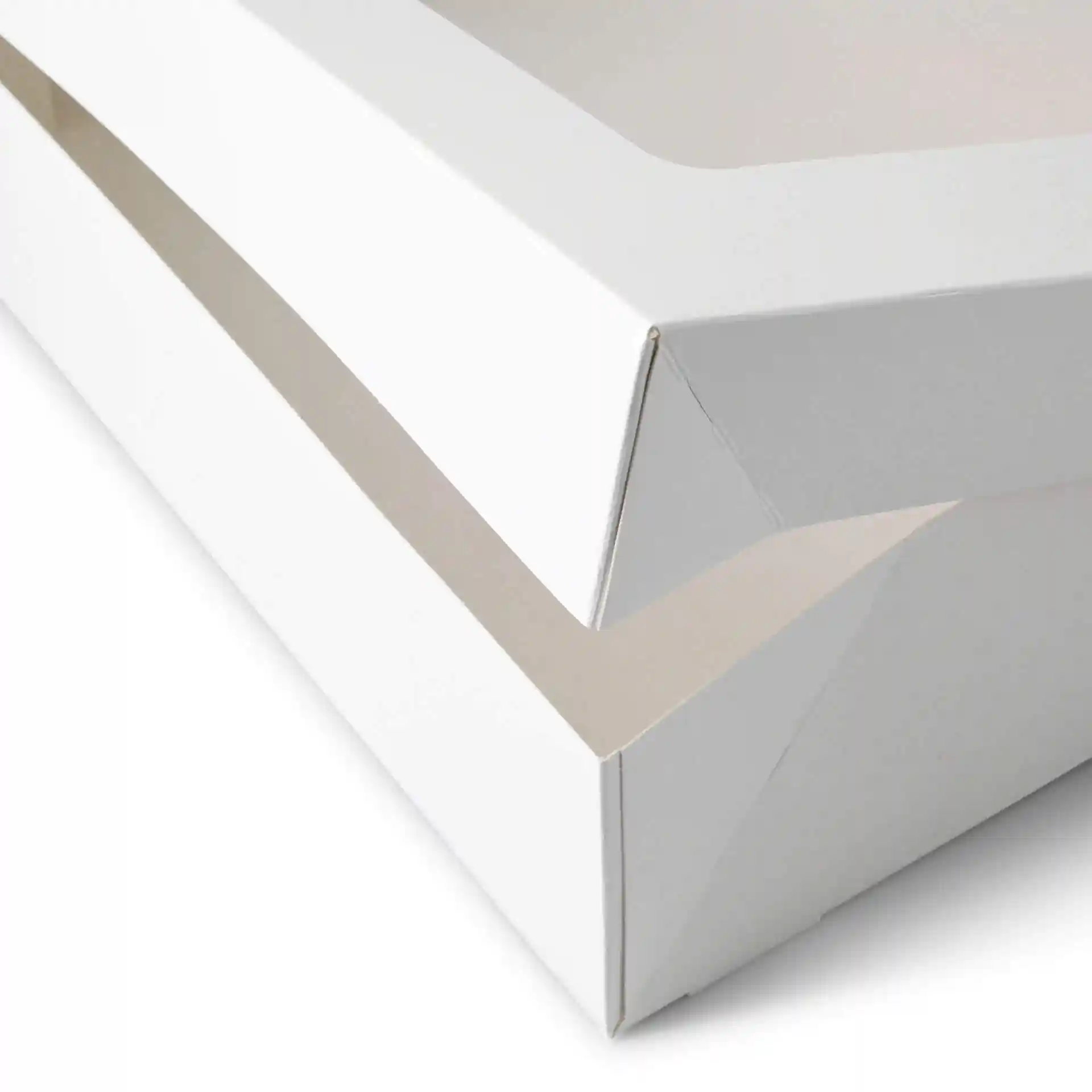 Close-up of a white cardboard cupcake box with a rectangular shape and a viewing window.