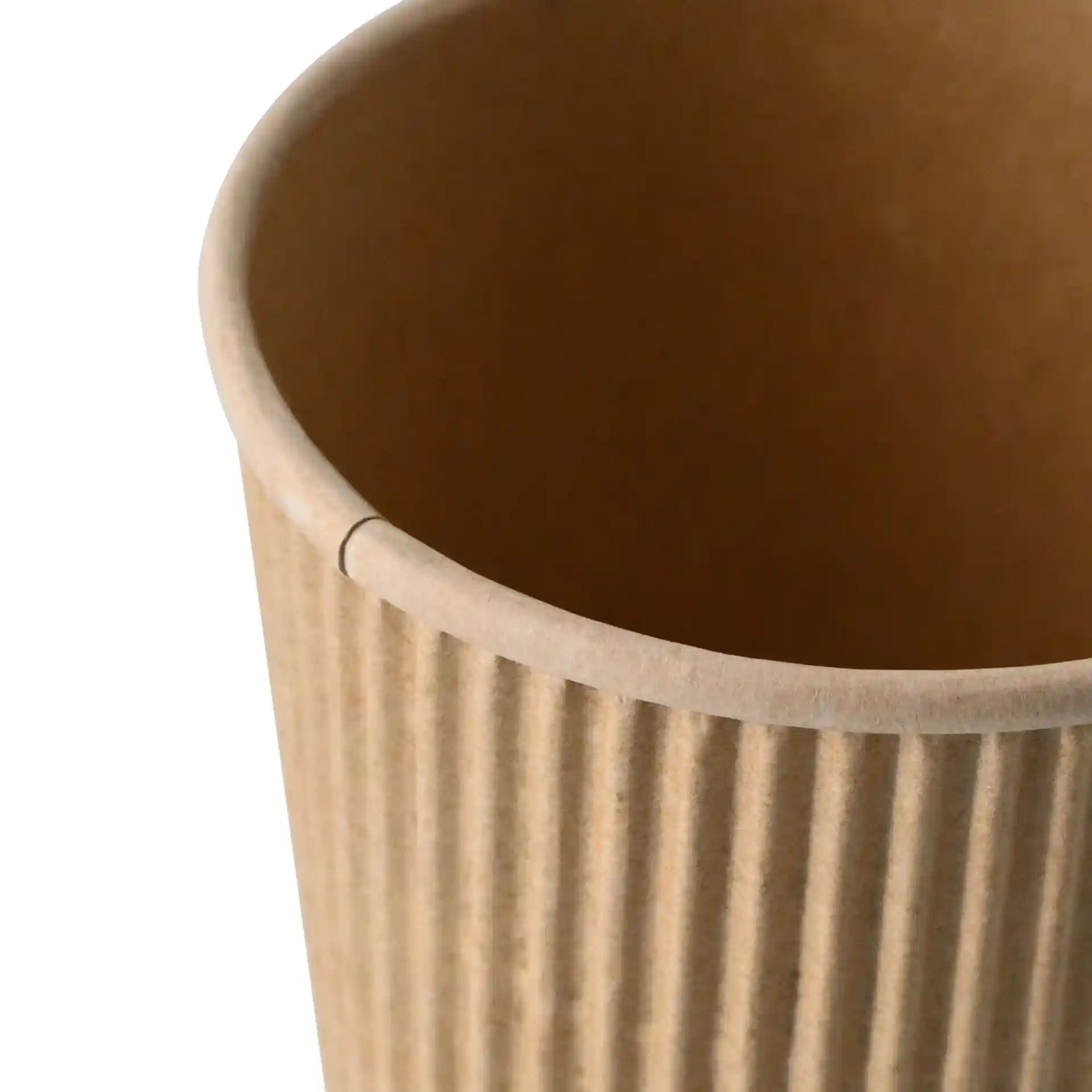 Close-up of a kraft paper cup with ribbed texture, showing the interior and top edge.