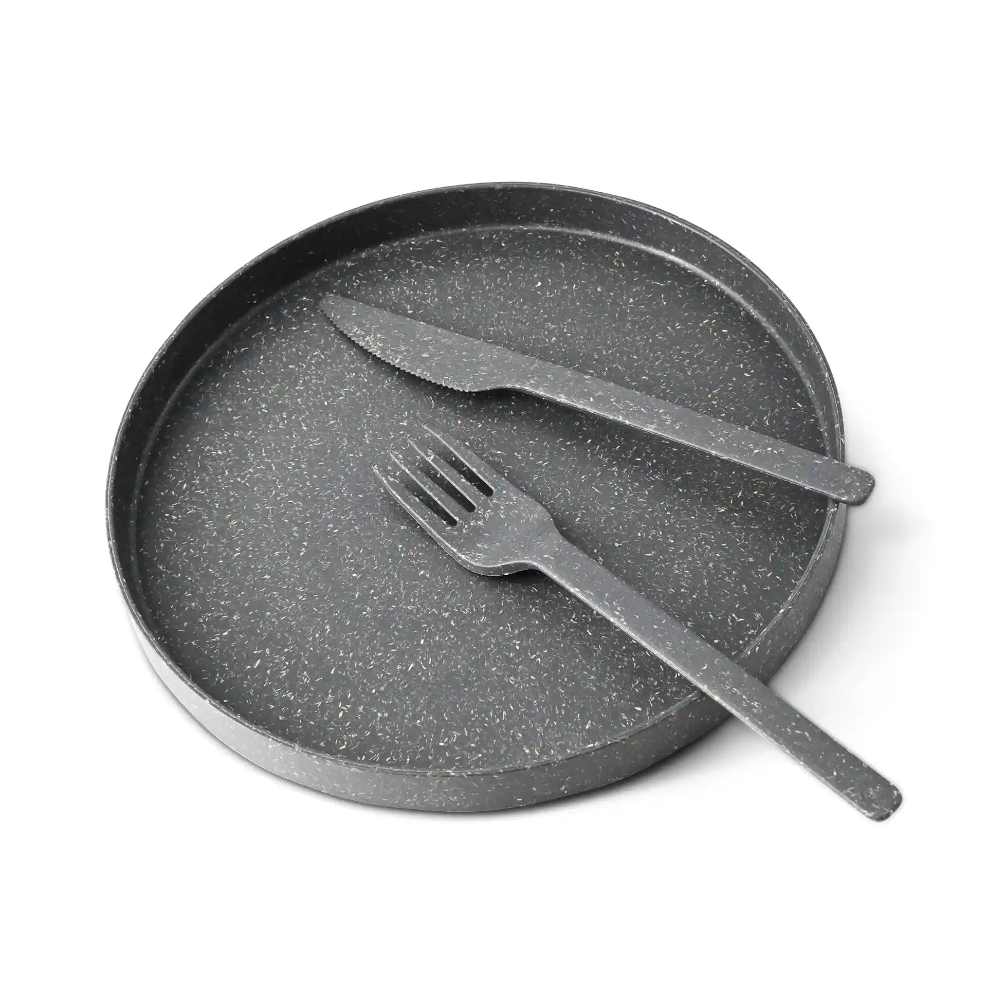 Black round tray with a textured surface, accompanied by a knife and fork, both in matching black.