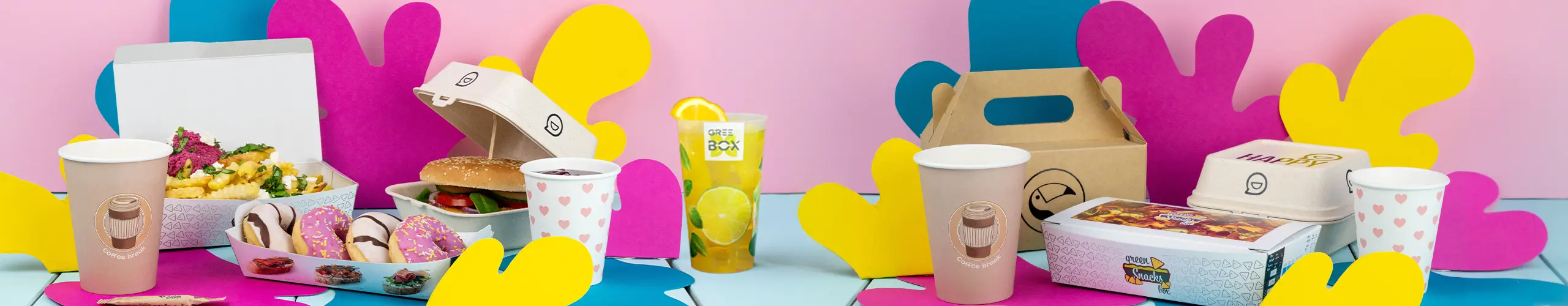 Assorted food items including a burger, fries, donuts, and drinks displayed with colorful paper cutouts on a table.