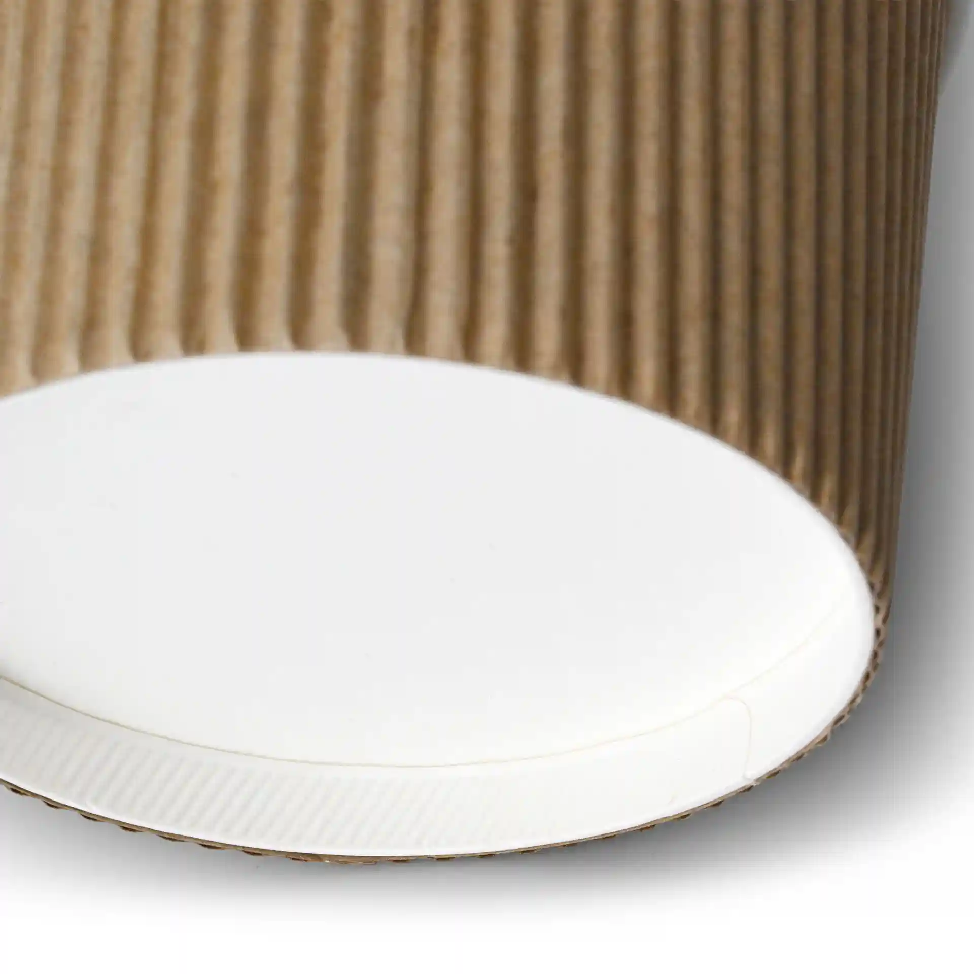 Close-up of a brown ribbed cardboard soup cup with a white base, showing the bottom and part of the side.