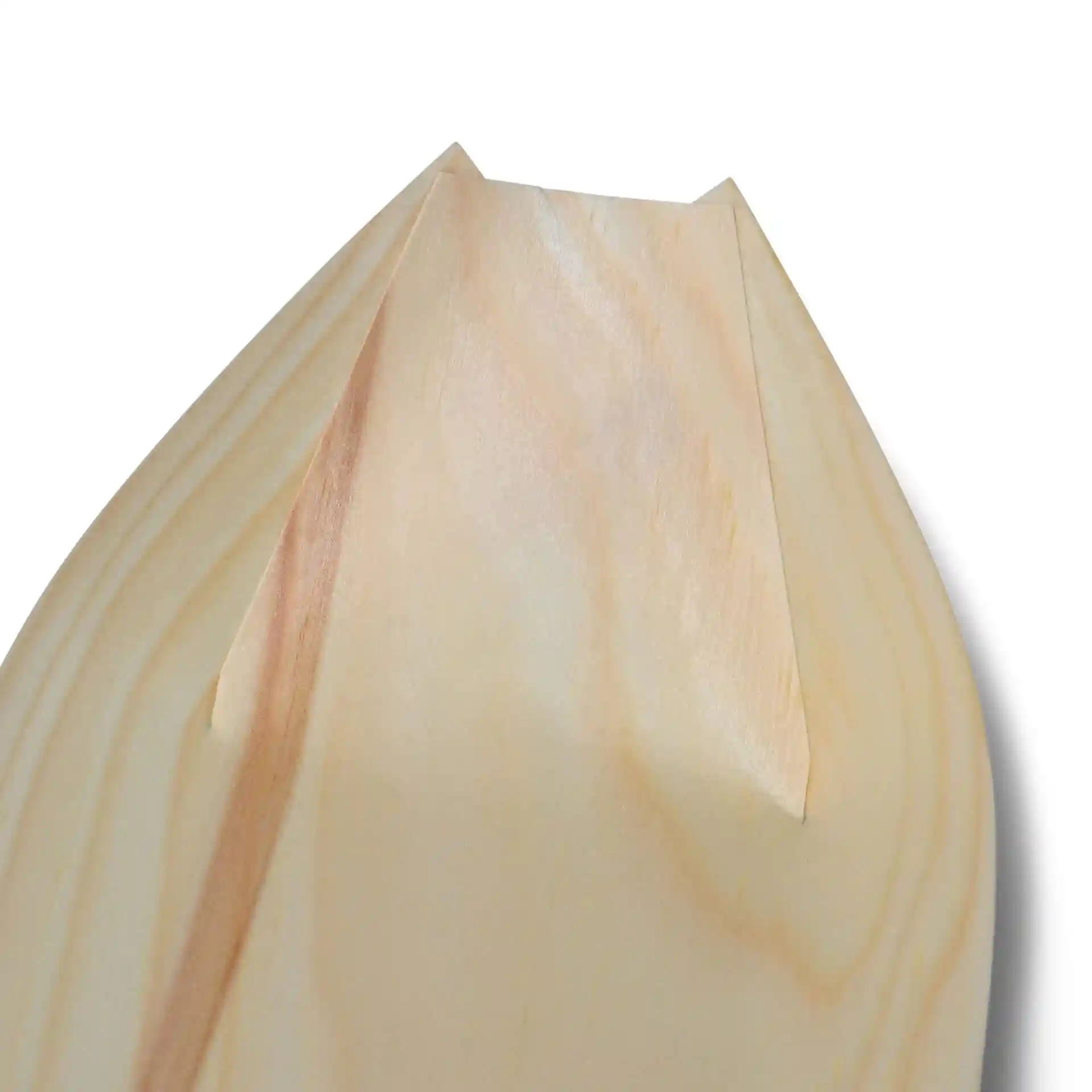 Close-up view of the tip of a wooden boat, featuring a smooth surface and pointed edges.