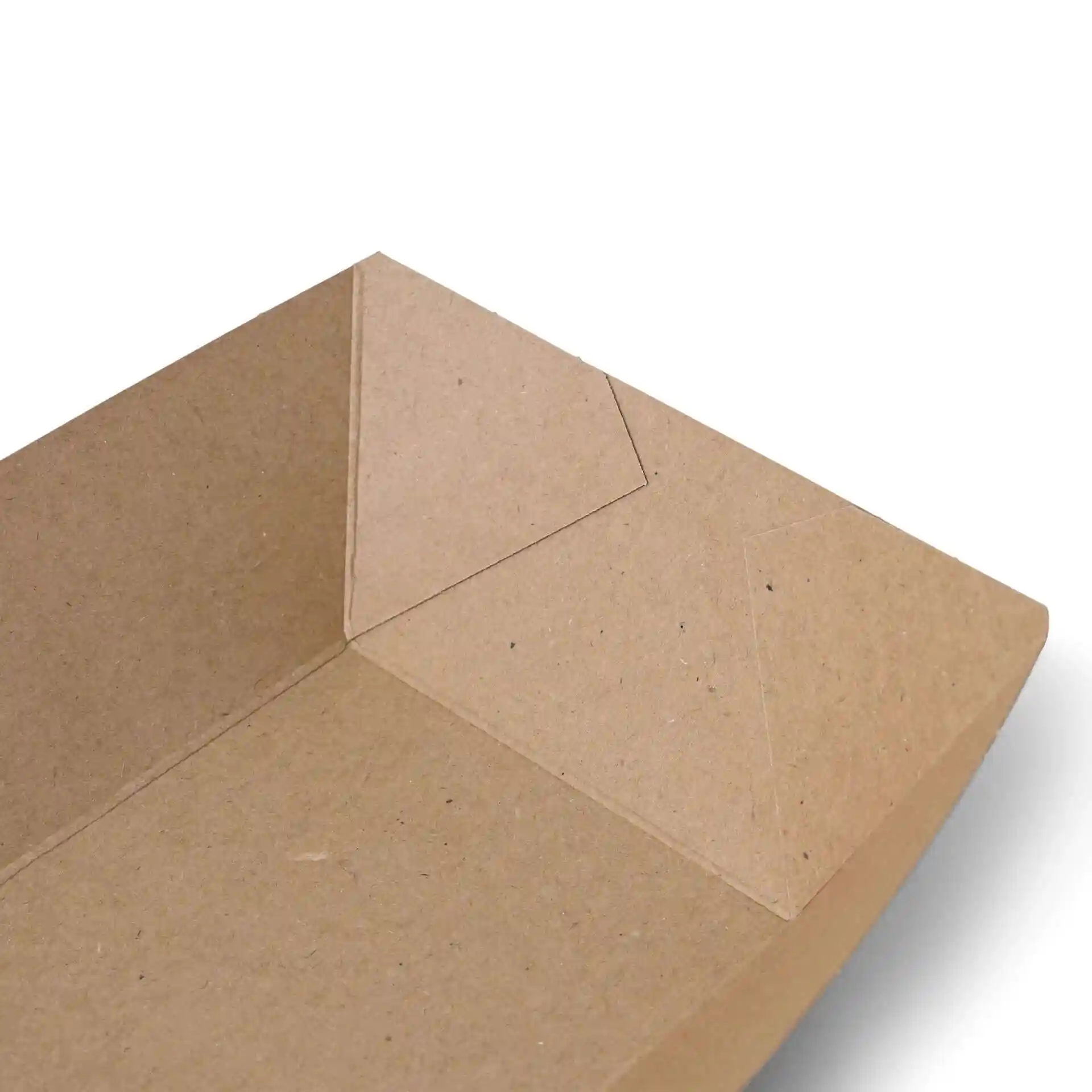 Close-up view of a brown cardboard food tray with angled corners and a flat base.