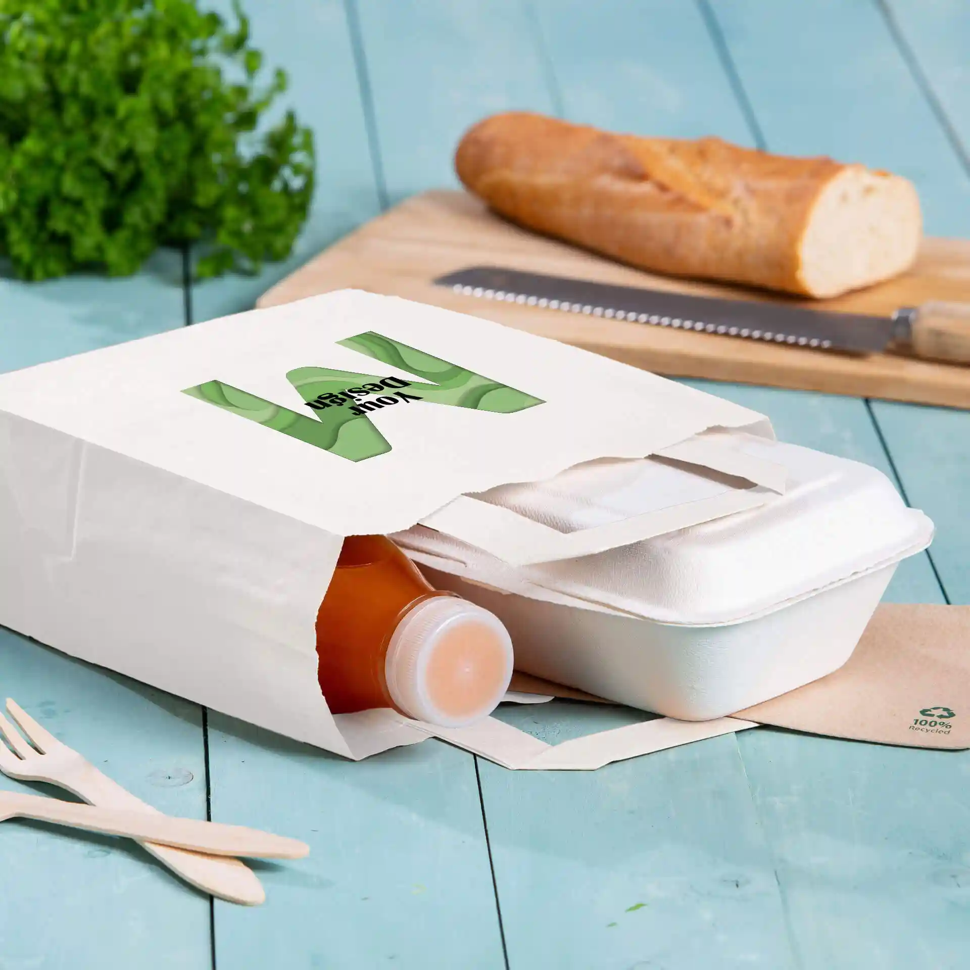 White paper carrier bag with a rectangular shape, containing a bottle and a food container, on a blue wooden surface.