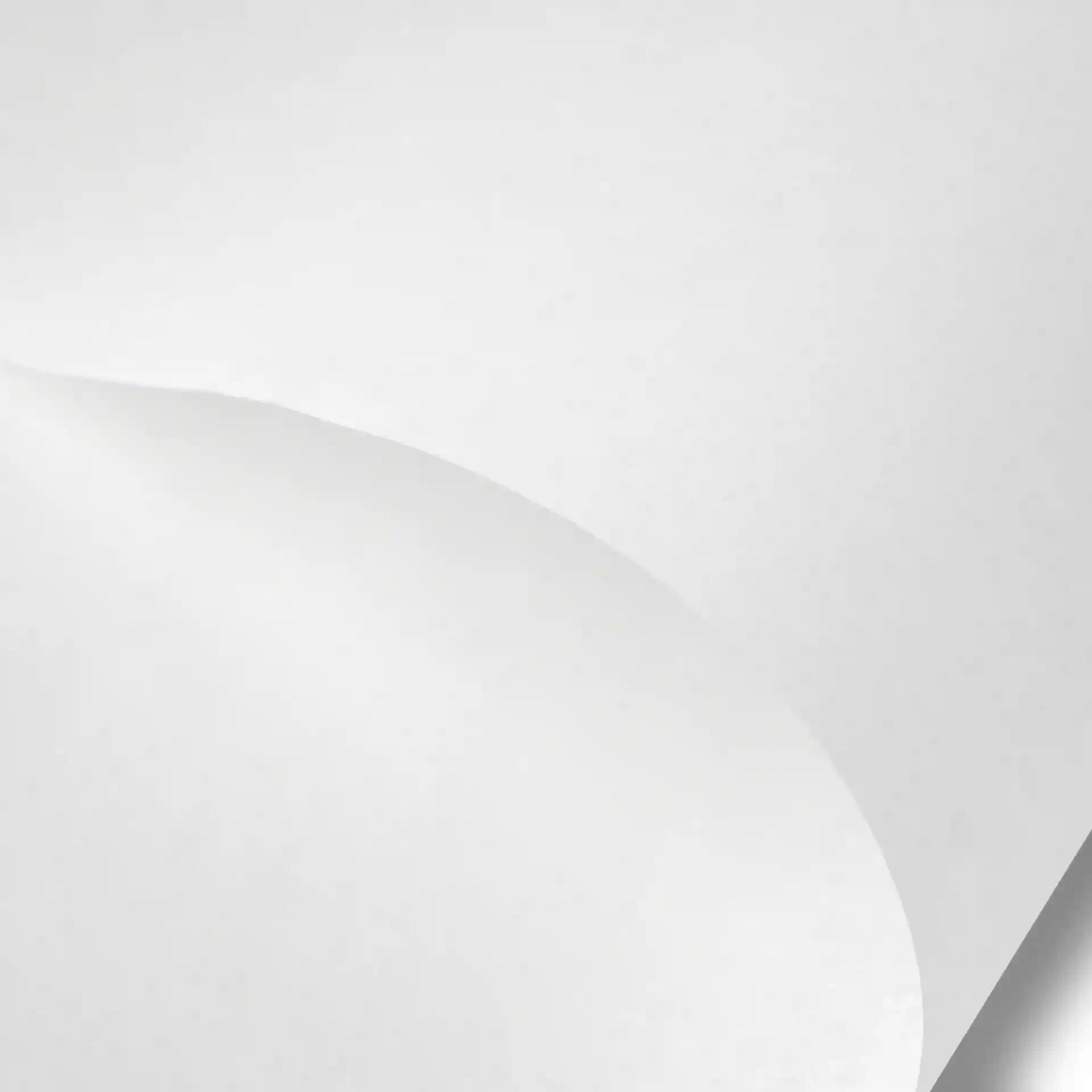 White wrapping paper sheet, 43 x 35 cm, with a smooth surface and a slight curl at the edge.