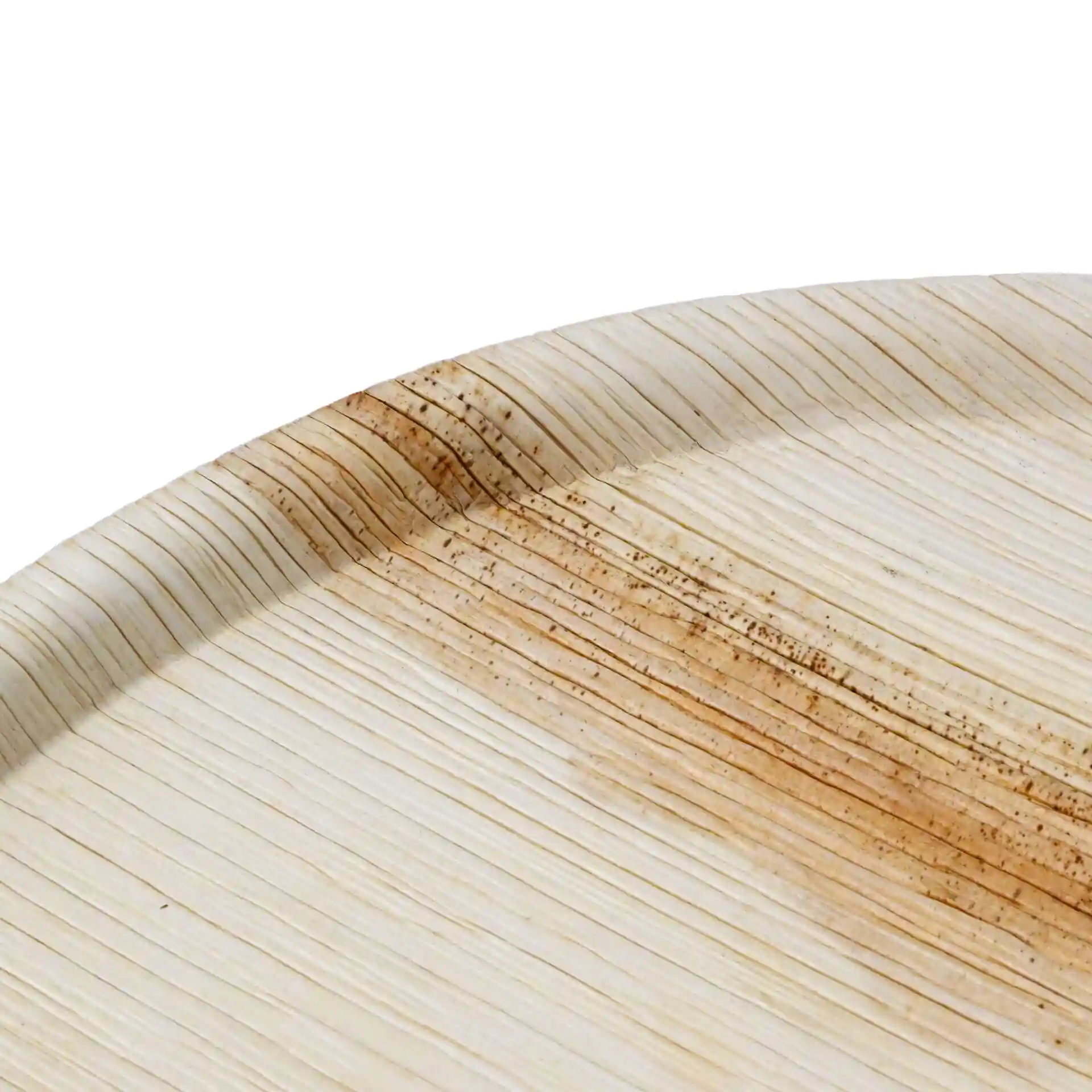 Round palm leaf pizza plate with a textured grain surface, showing a slight brownish hue along the edge.
