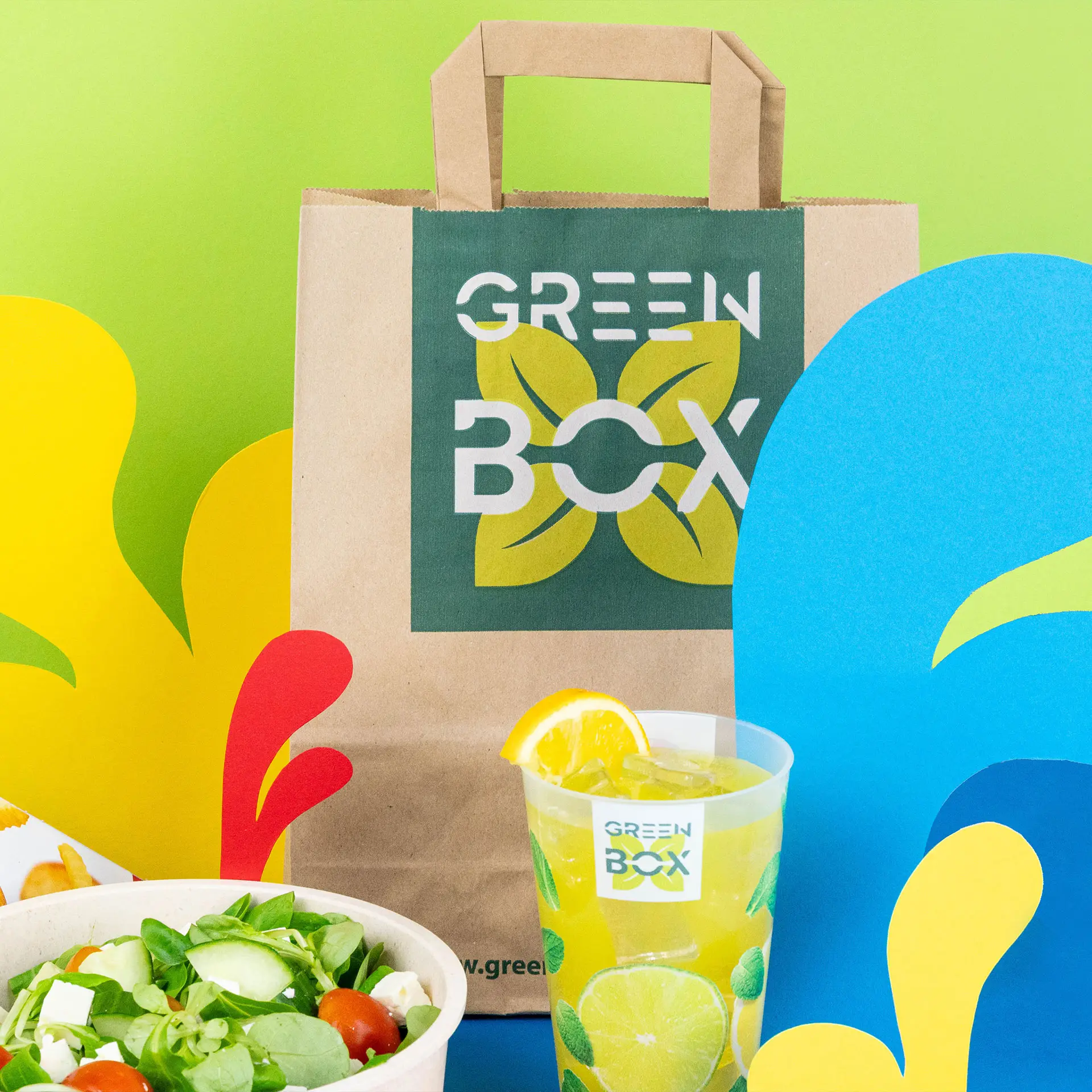 Customizable brown paper carrier bag with handles; features a large 'S' and "Your Design" print. Ideal for branding.