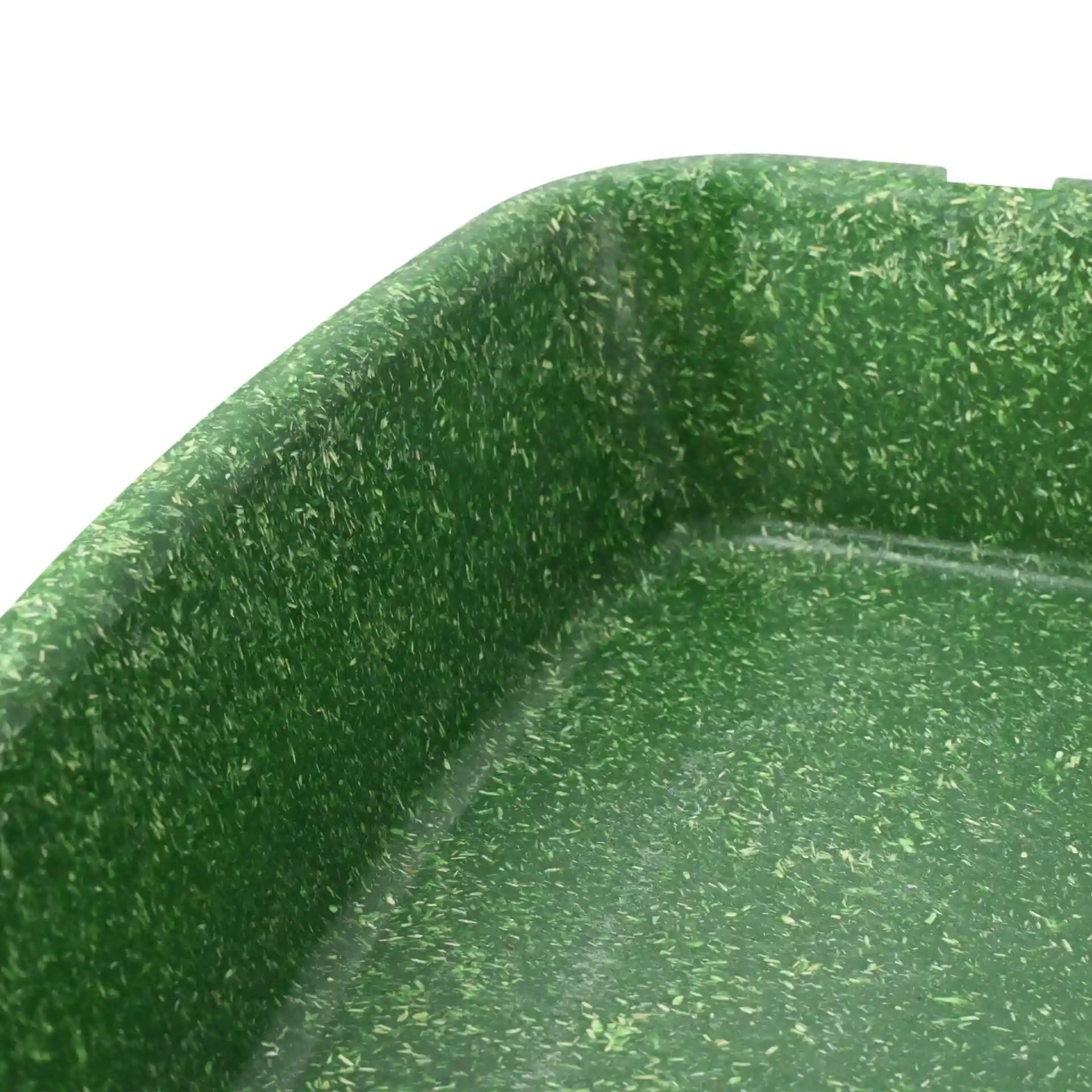 Deep green reusable meal container with two compartments, showing the interior corner and textured surface.