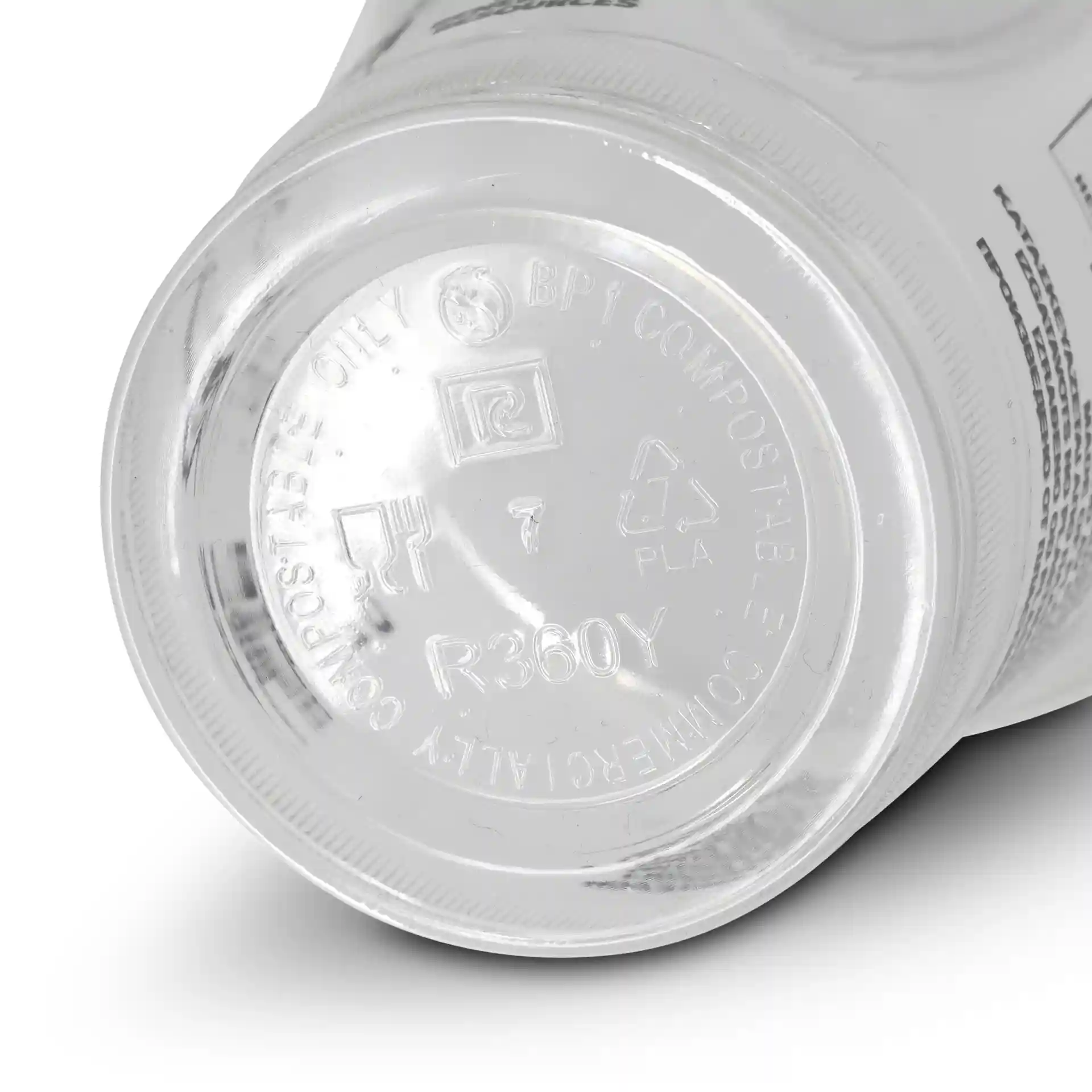 Bottom view of a transparent 12 oz PLA smoothie cup showing a circular base with various markings and symbols.