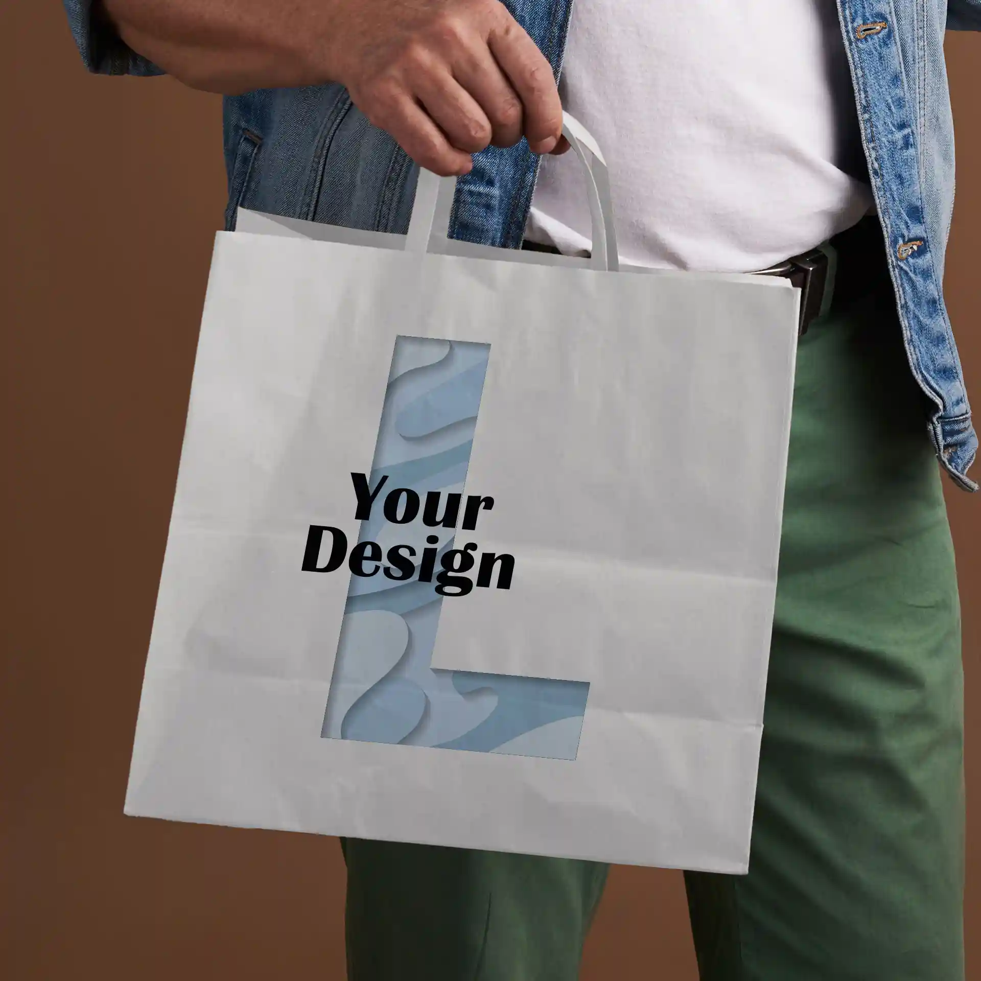 White paper carrier bag with a rectangular shape, featuring a cut-out design and text on the front.