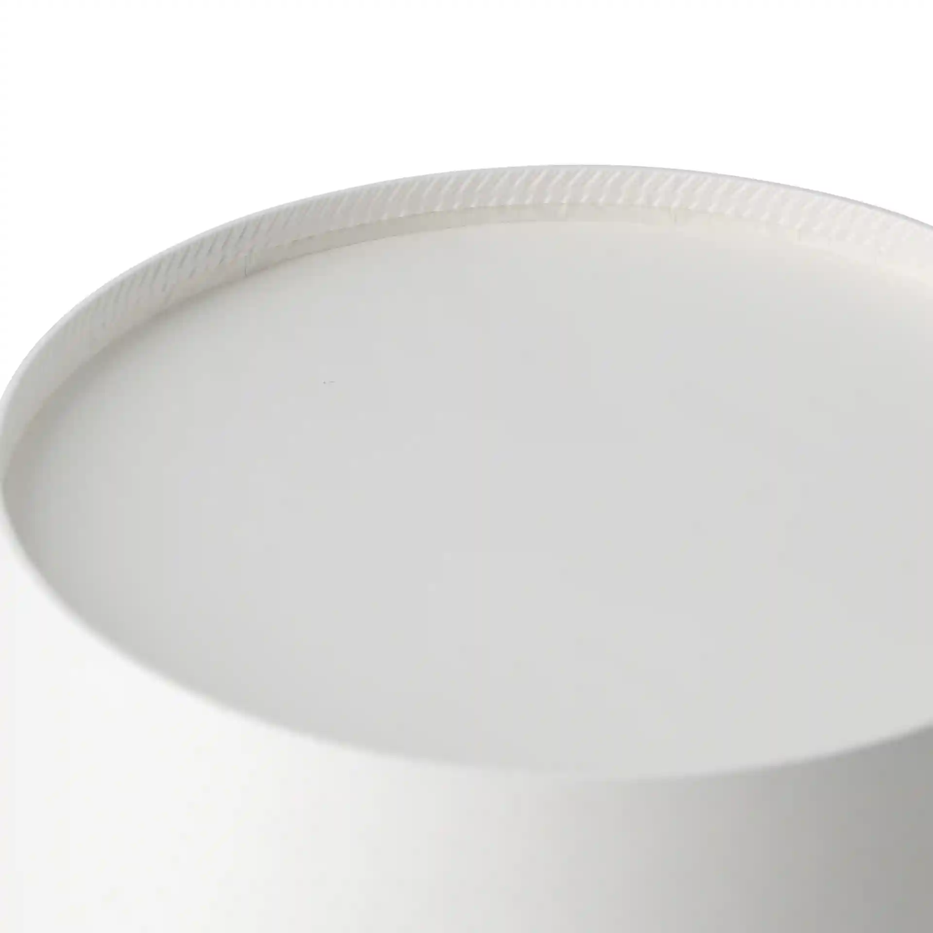 Close-up of the top edge of a round white cardboard bowl with a textured rim.