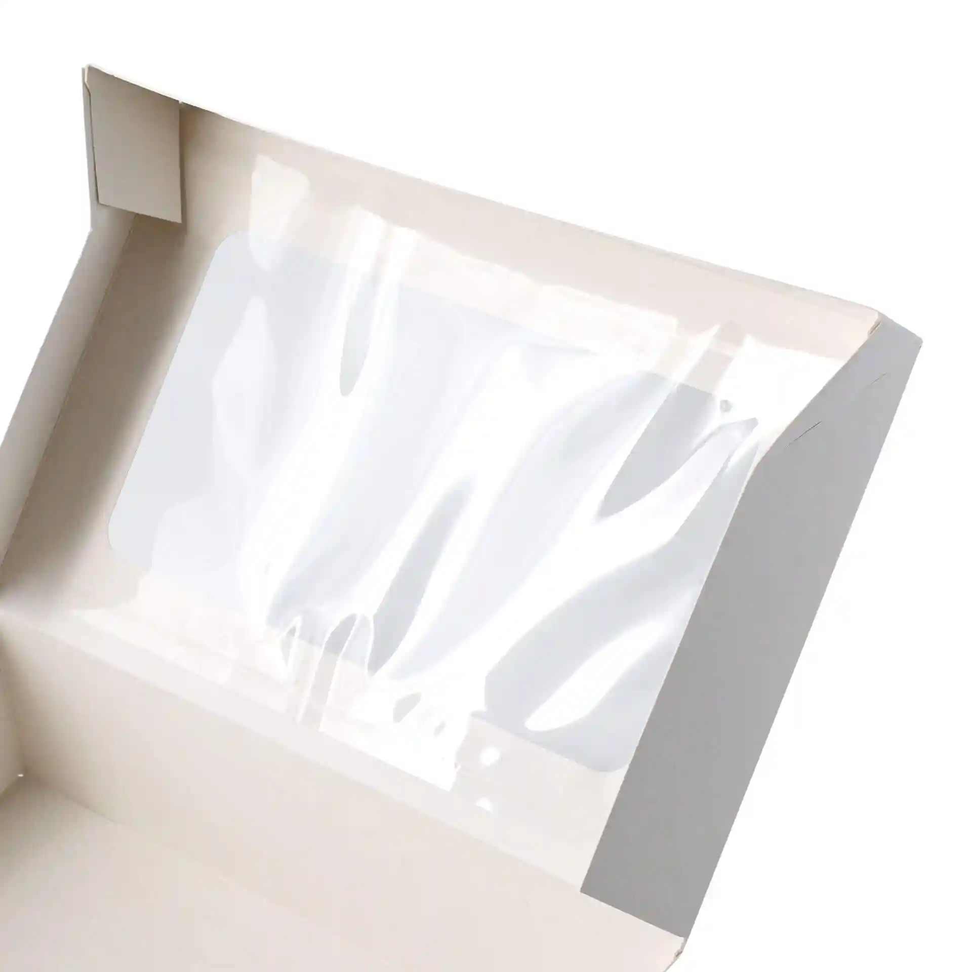 Interior view of a white cardboard cupcake box featuring a clear cellulose window.