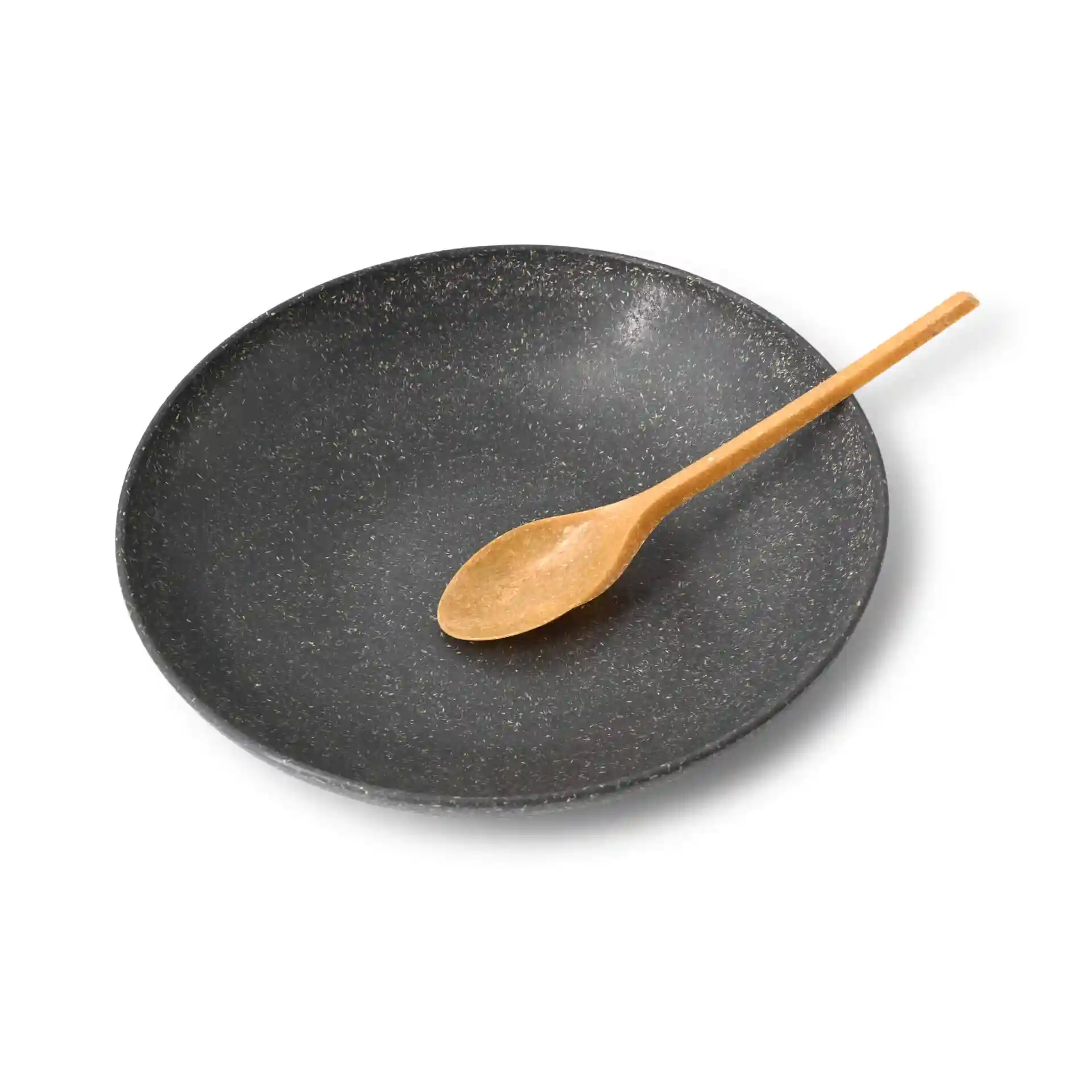 Black plate with a brown reusable spoon resting on its edge.