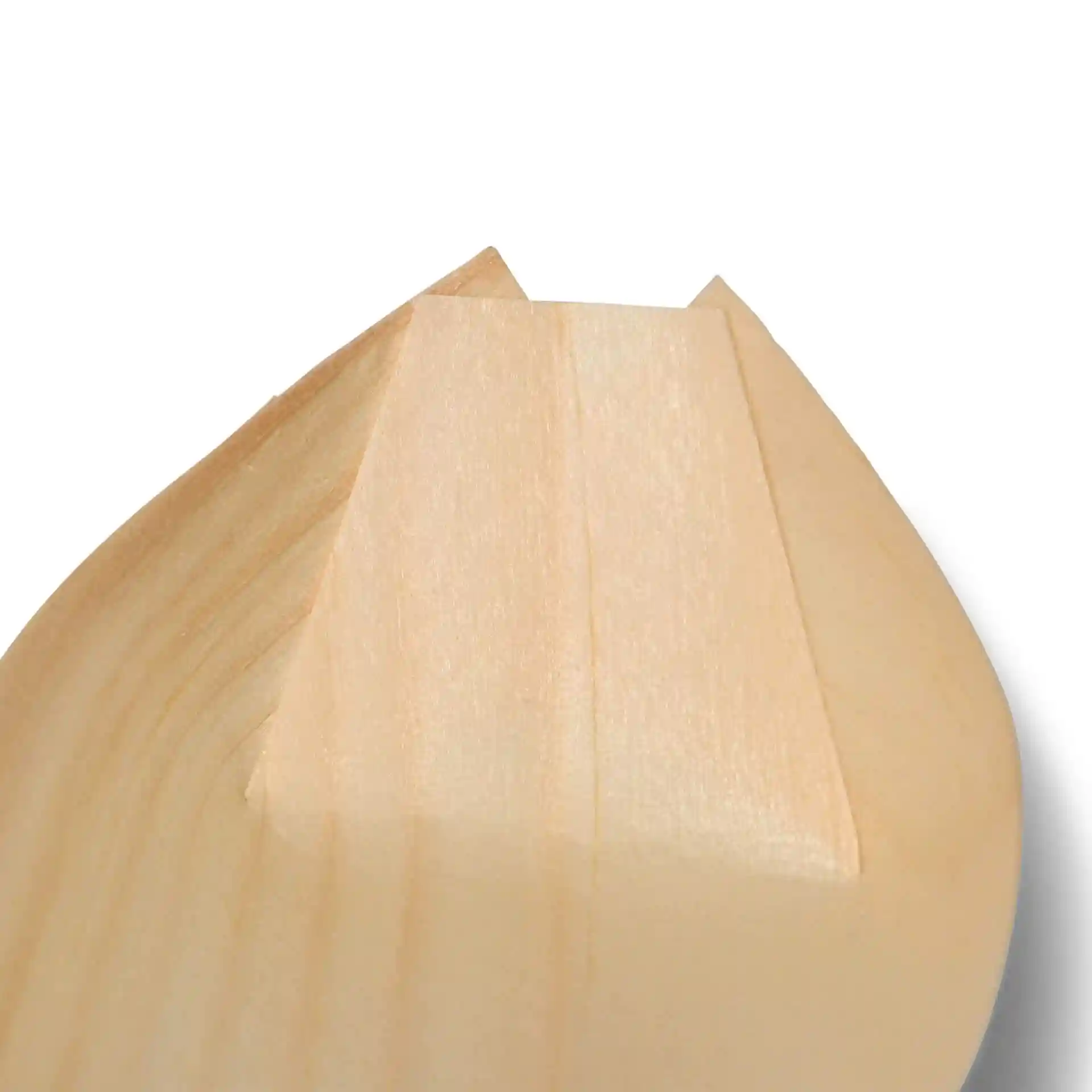 Close-up of the pointed tip of a wooden boat-shaped item, showing smooth wood grain and a light brown color.