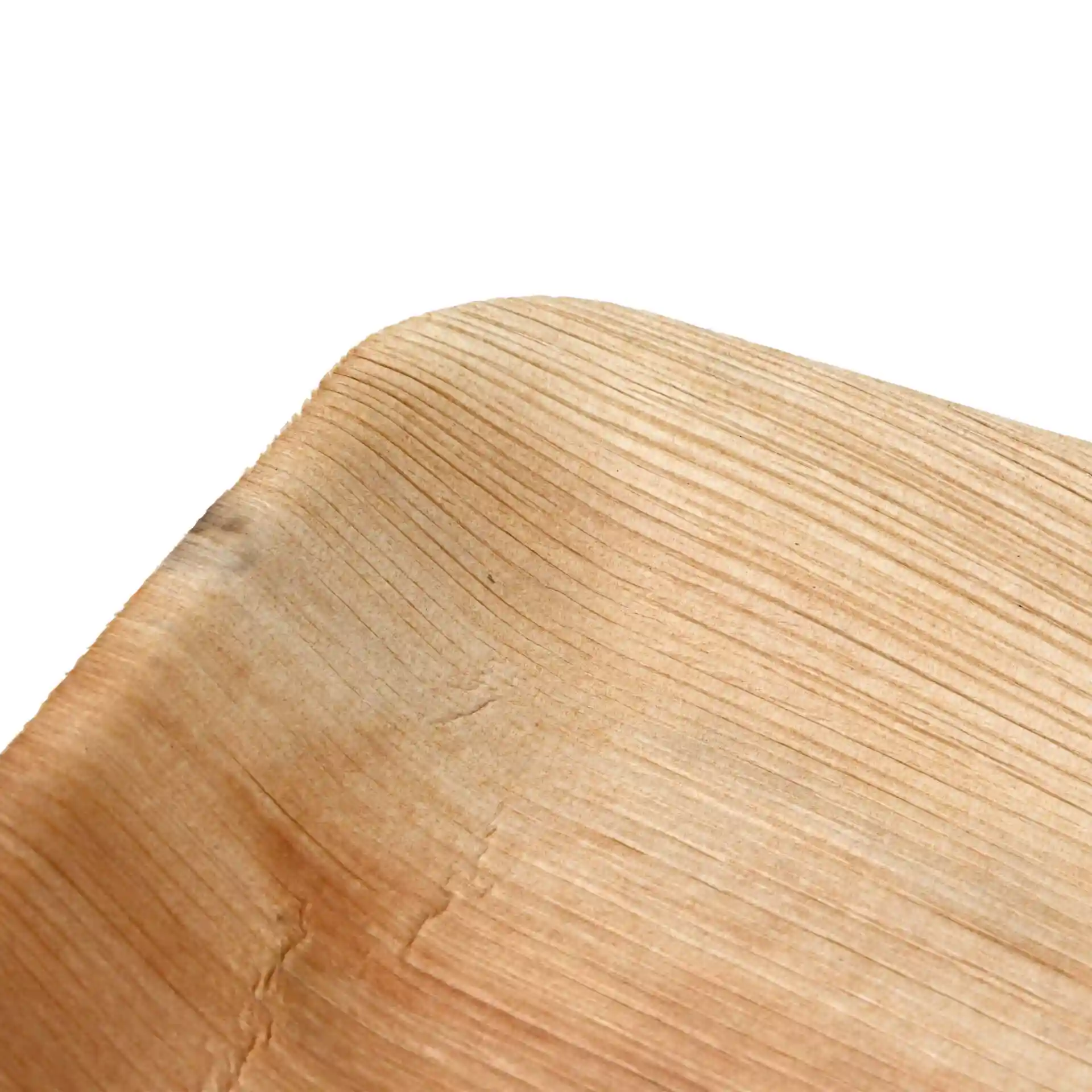 Close-up of a rectangular palm leaf plate with visible grain texture and rounded edges.