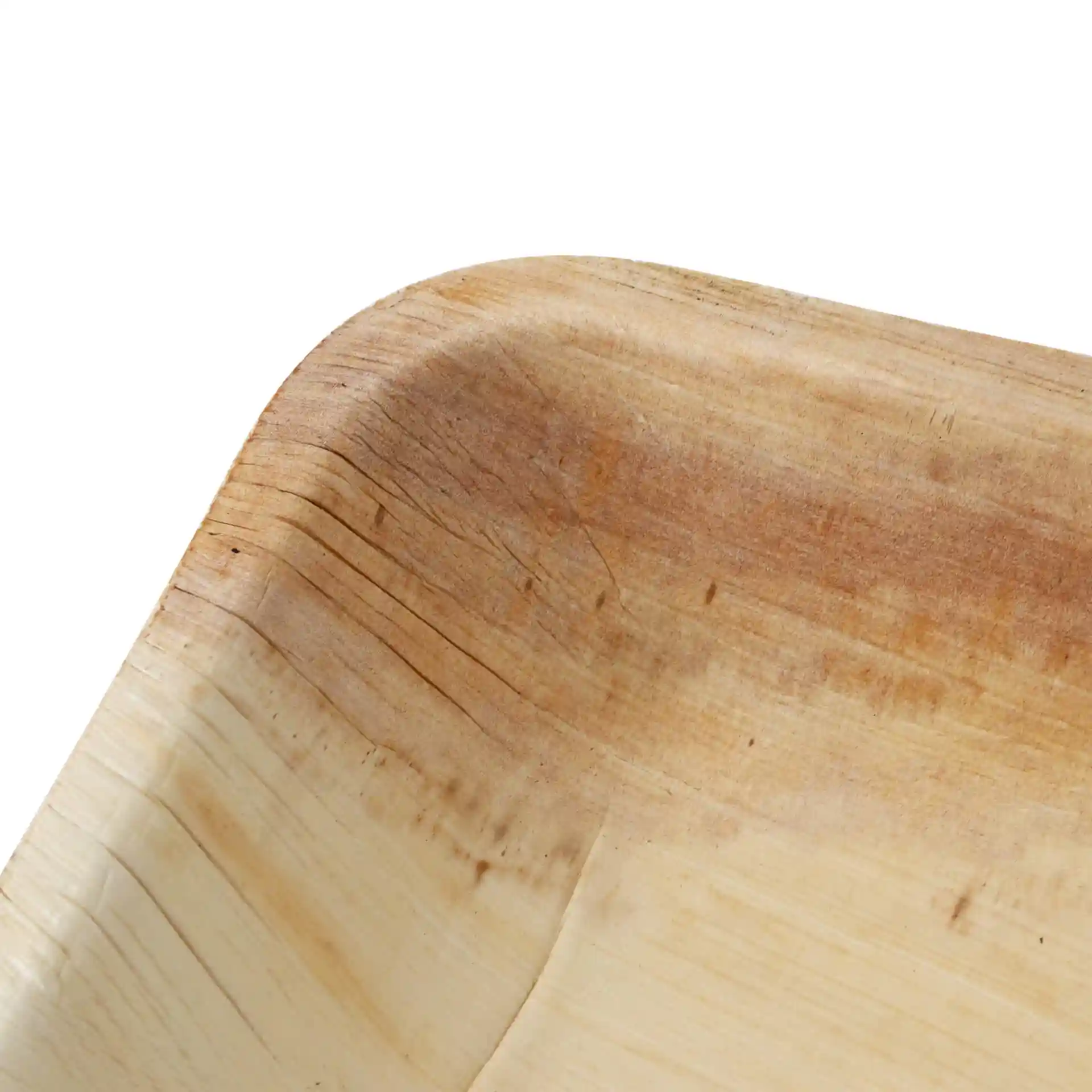 Close-up of a rectangular palm leaf plate with a smooth, natural grain and rounded edges.