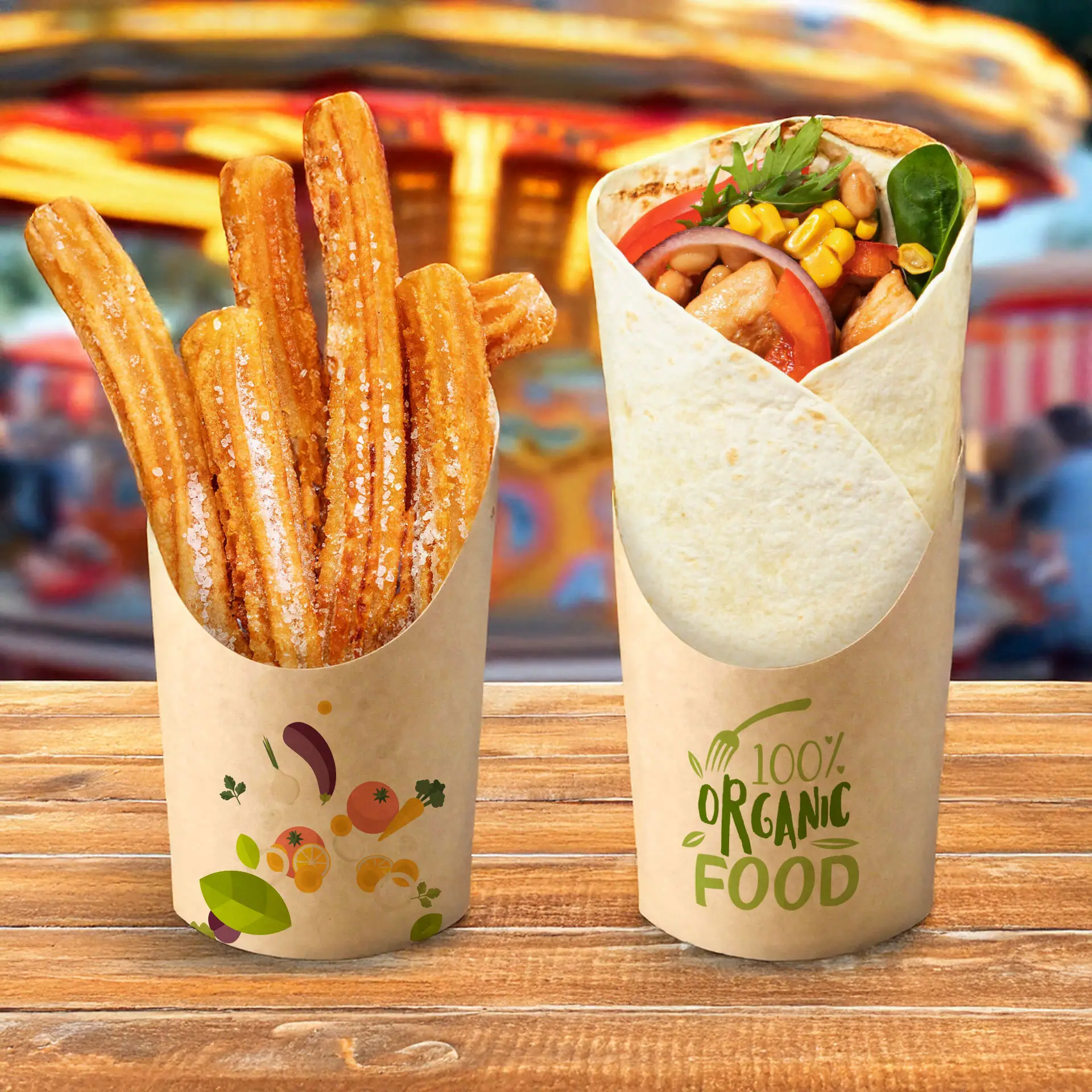 Churros in a kraft cardboard cup and a wrap filled with assorted ingredients in a similar cup, on a wooden table.