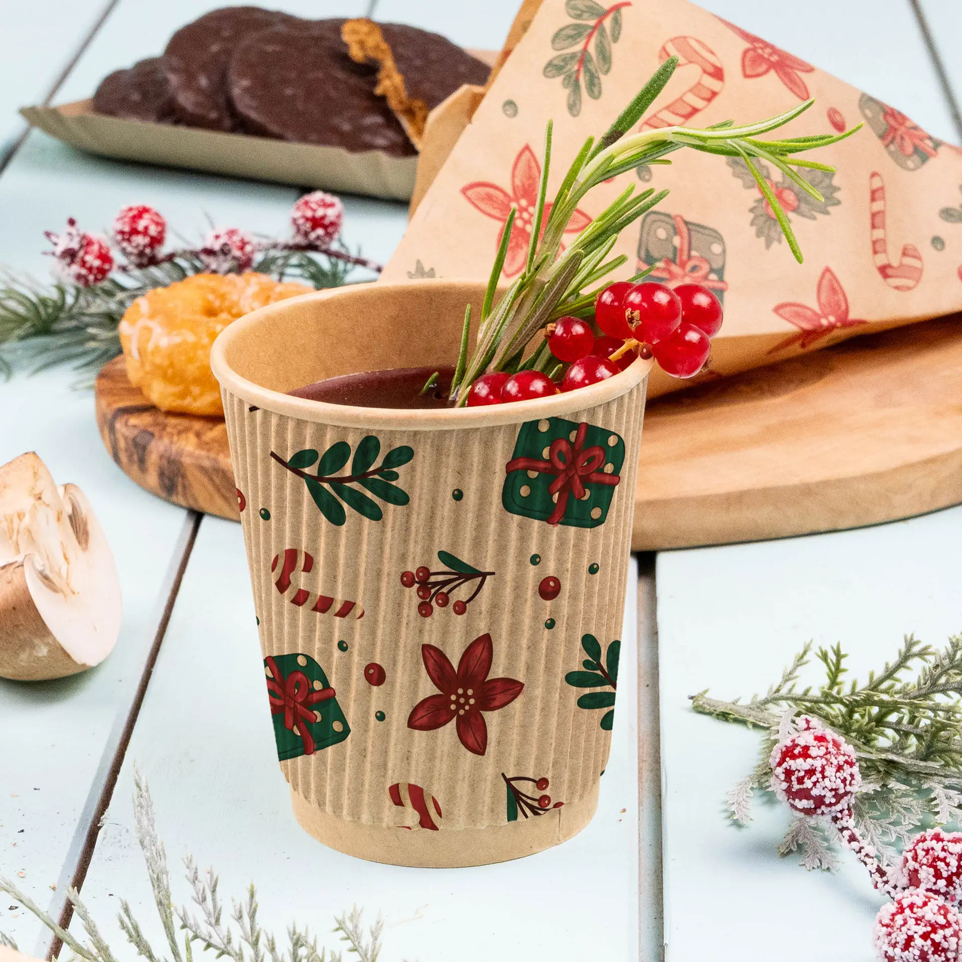 Brown ripple cup with winter design, filled with a beverage and garnished with red berries and rosemary.