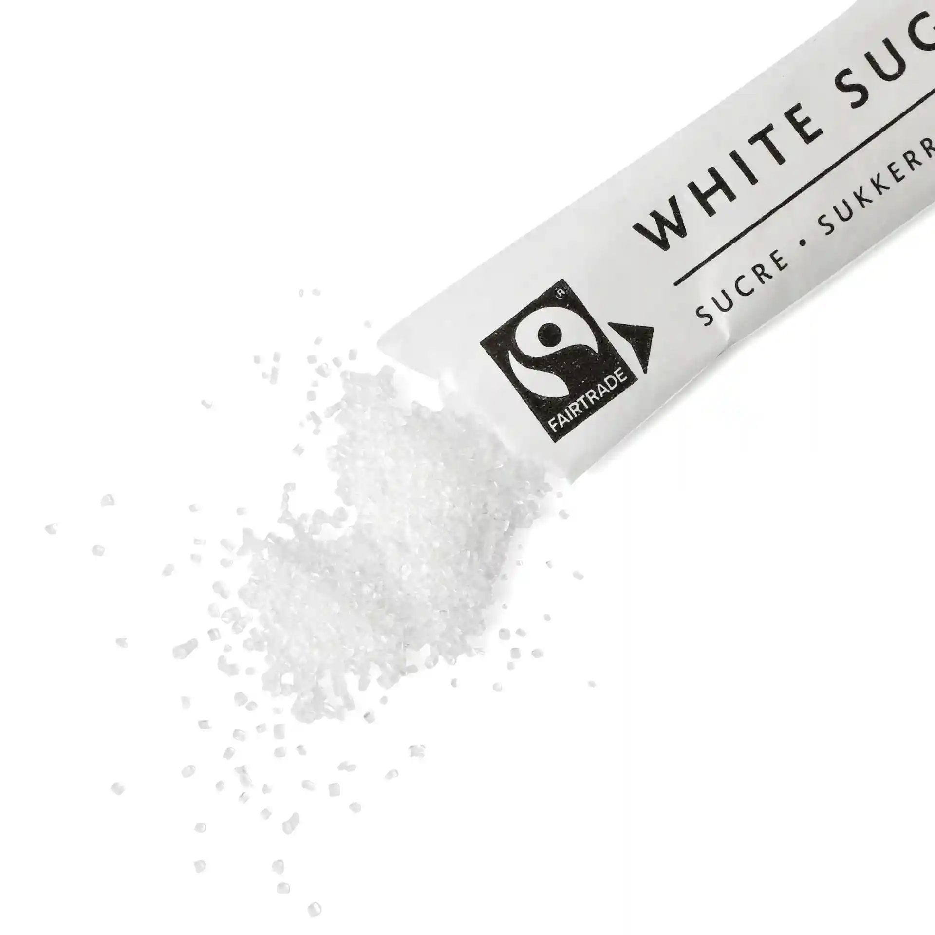 White sugar spilling from a paper stick, with visible granules and a Fairtrade logo on the packaging.