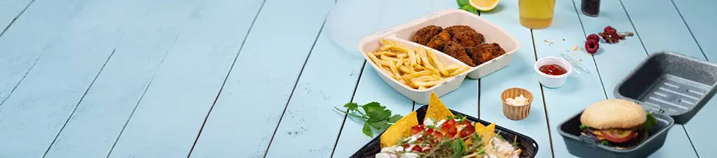 Chef character with a green head and white hat, holding a spoon; two food containers with a burger and a meal with fries and chicken on a blue wooden background.