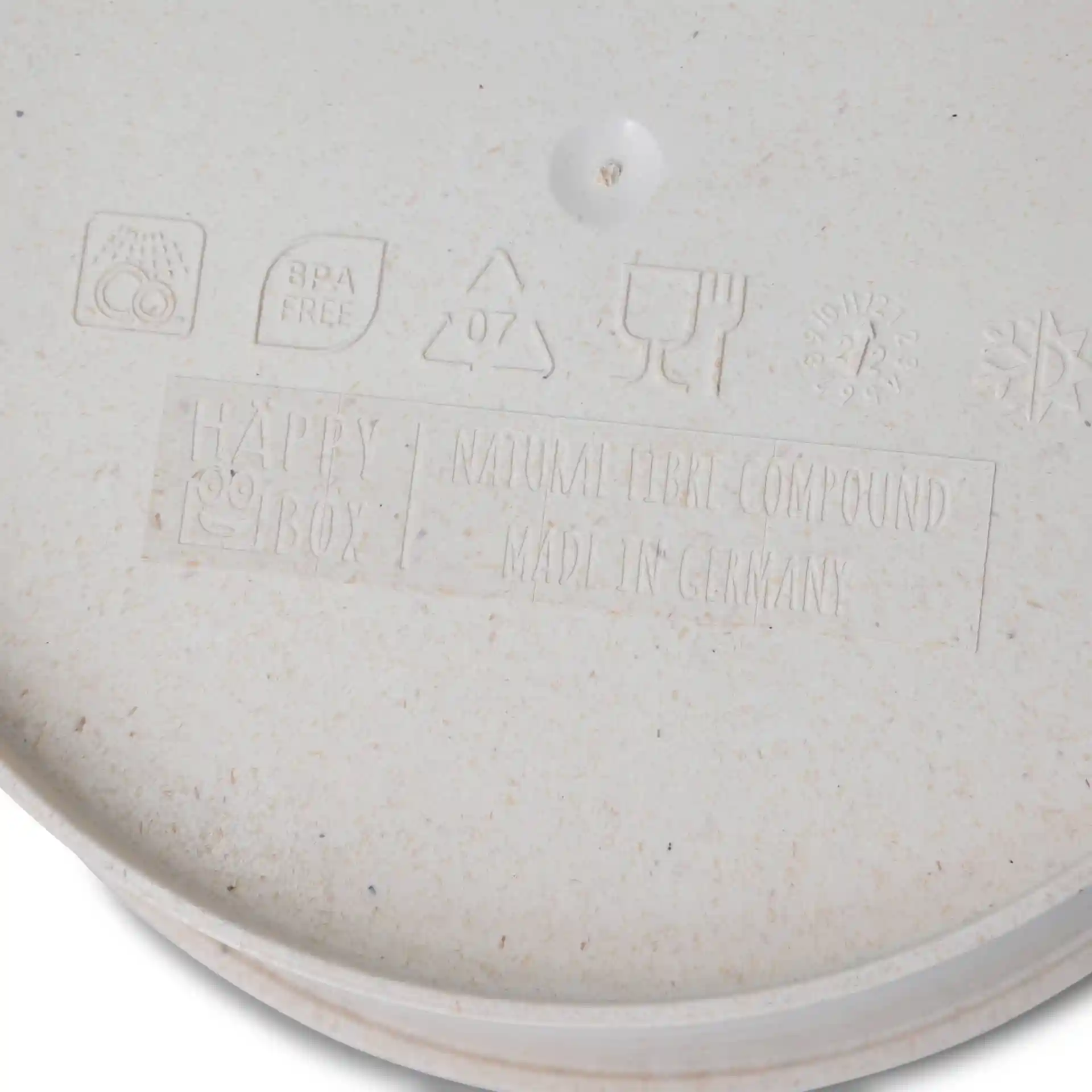 Round cream white reusable bowl made from bio compound, showing embossed markings and symbols on the bottom.