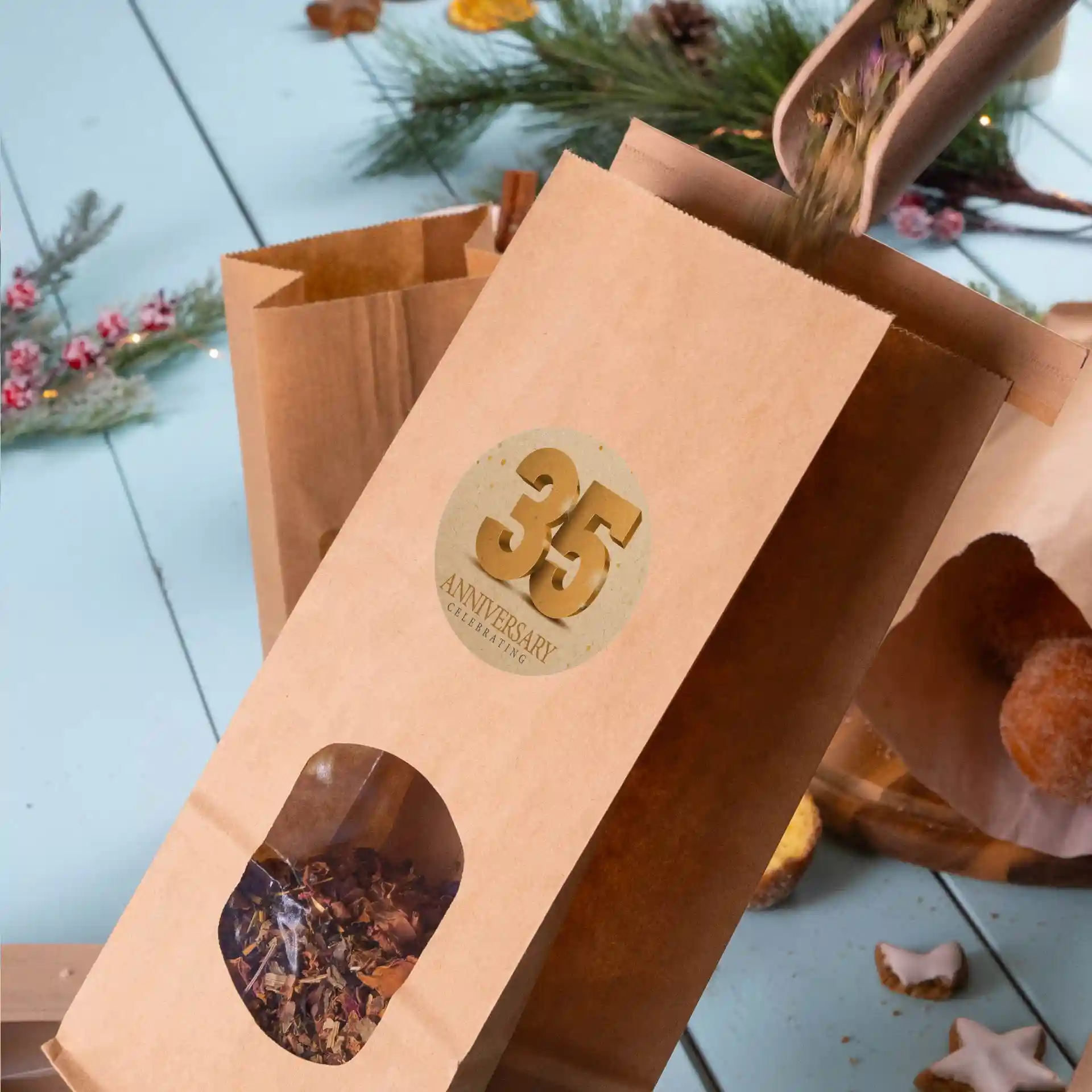 Brown kraft paper bag with a round window showing contents, featuring a printed label with a 35th anniversary design.