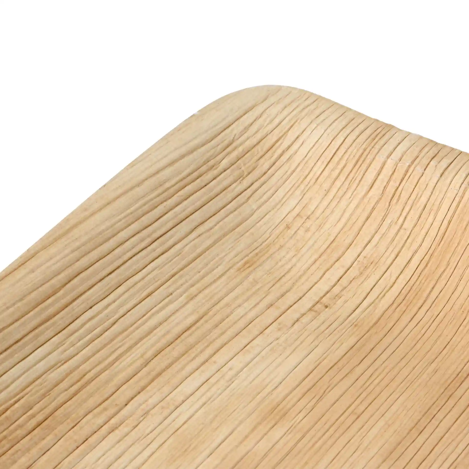 Close-up of a square palm leaf plate with a textured grain surface and rounded edges.