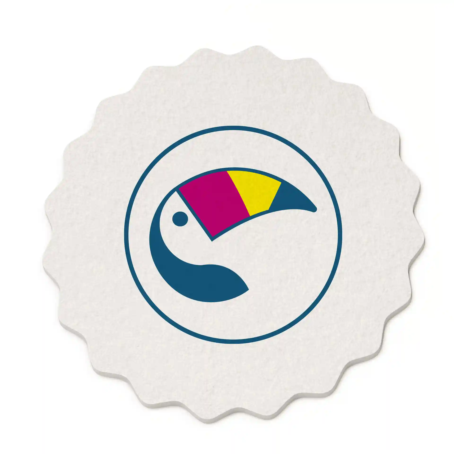Round, scalloped drink coaster featuring a colorful toucan design on a white background, measuring 10 cm in diameter.