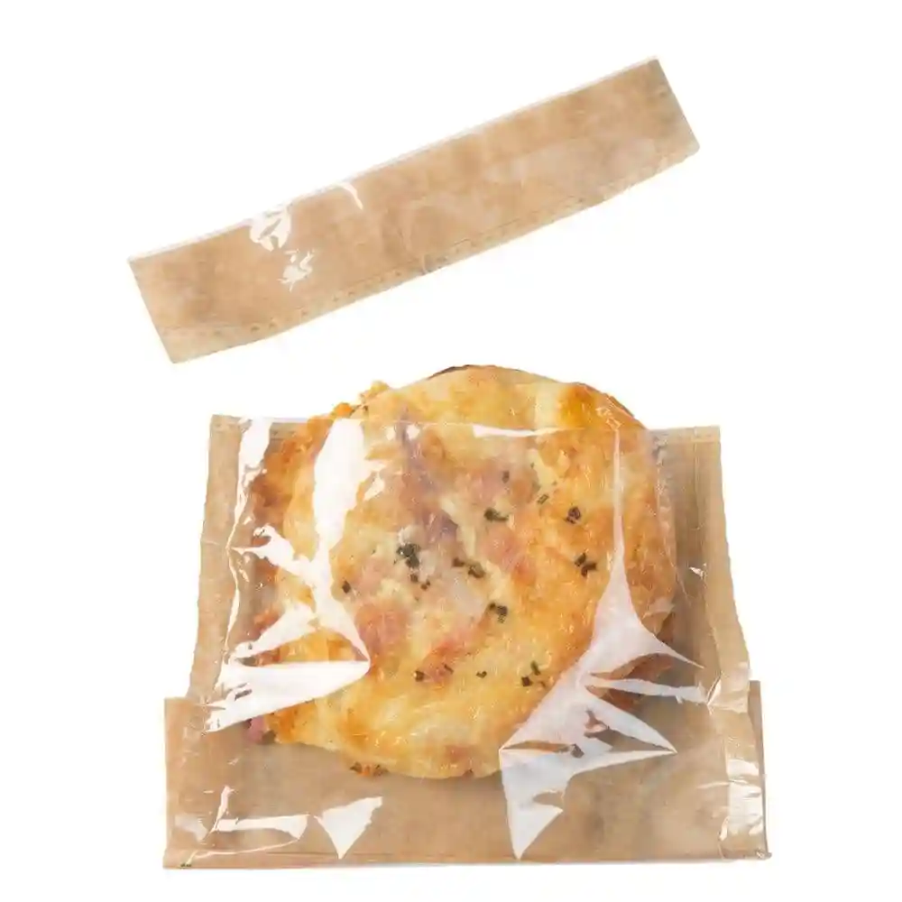 Snack bag made of paper with a palm leaf print, containing a baked item wrapped in clear film.